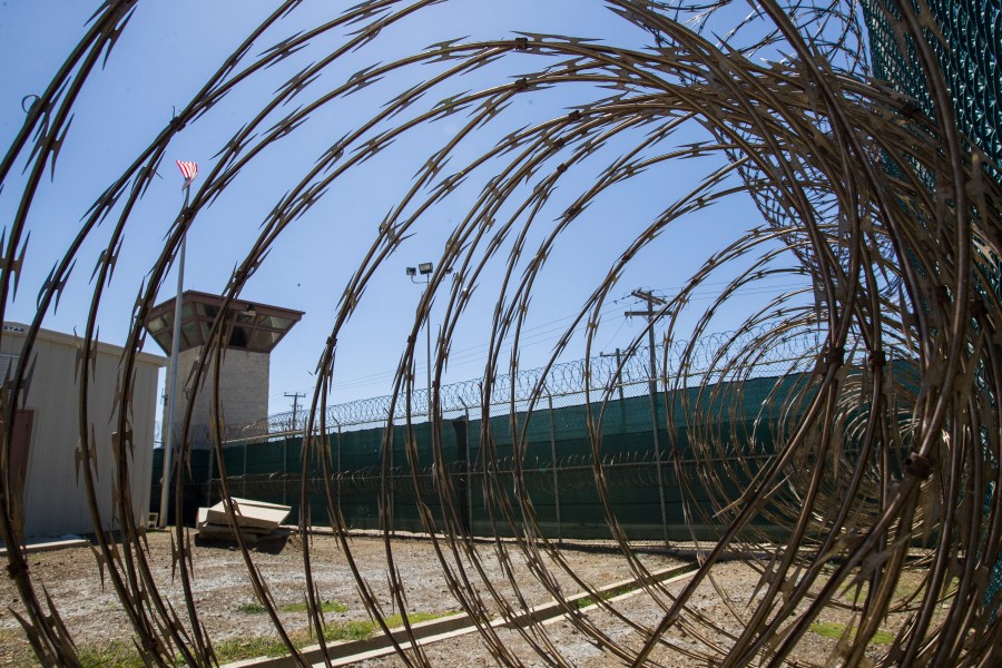 FILE - In this April 17, 2019, photo, reviewed by U.S. military officials, the control tower is seen through the razor wire inside the Camp VI detention facility in Guantanamo Bay Naval Base, Cuba. (AP Photo/Alex Brandon, File)