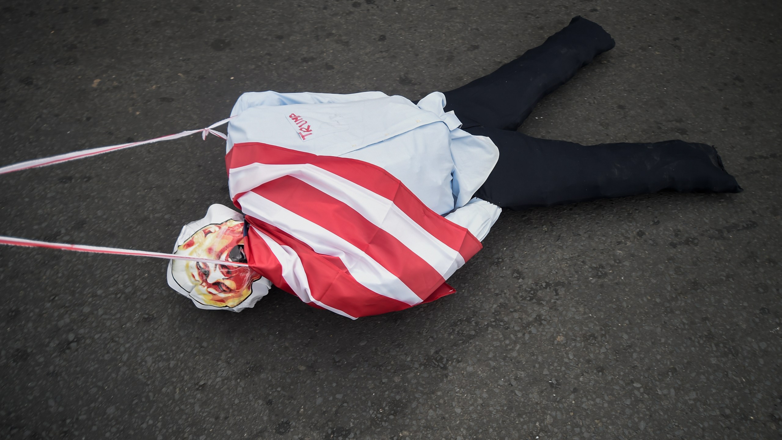 An effigy of President-elect Donald Trump is dragged on a street during a demonstration marking Martyrs' Day, a national day of mourning to honor the 21 Panamanians who were killed during the January 1964 anti-American riots over sovereignty of the Panama Canal Zone, in Panama City, Thursday, Jan. 9, 2025. (AP Photo/Agustin Herrera)