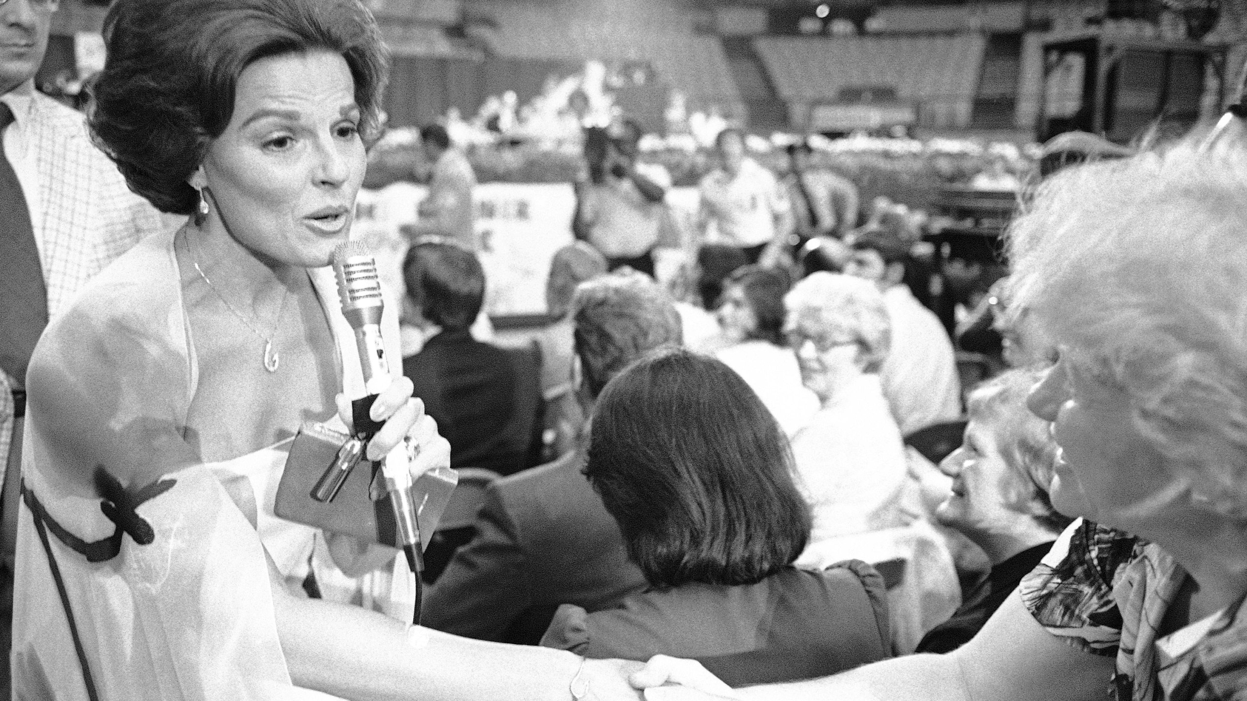 FILE - Anita Bryant shakes the hand of a member of the audience at the Civic Arena in Pittsburgh on May 22, 1978. (AP Photo, File)