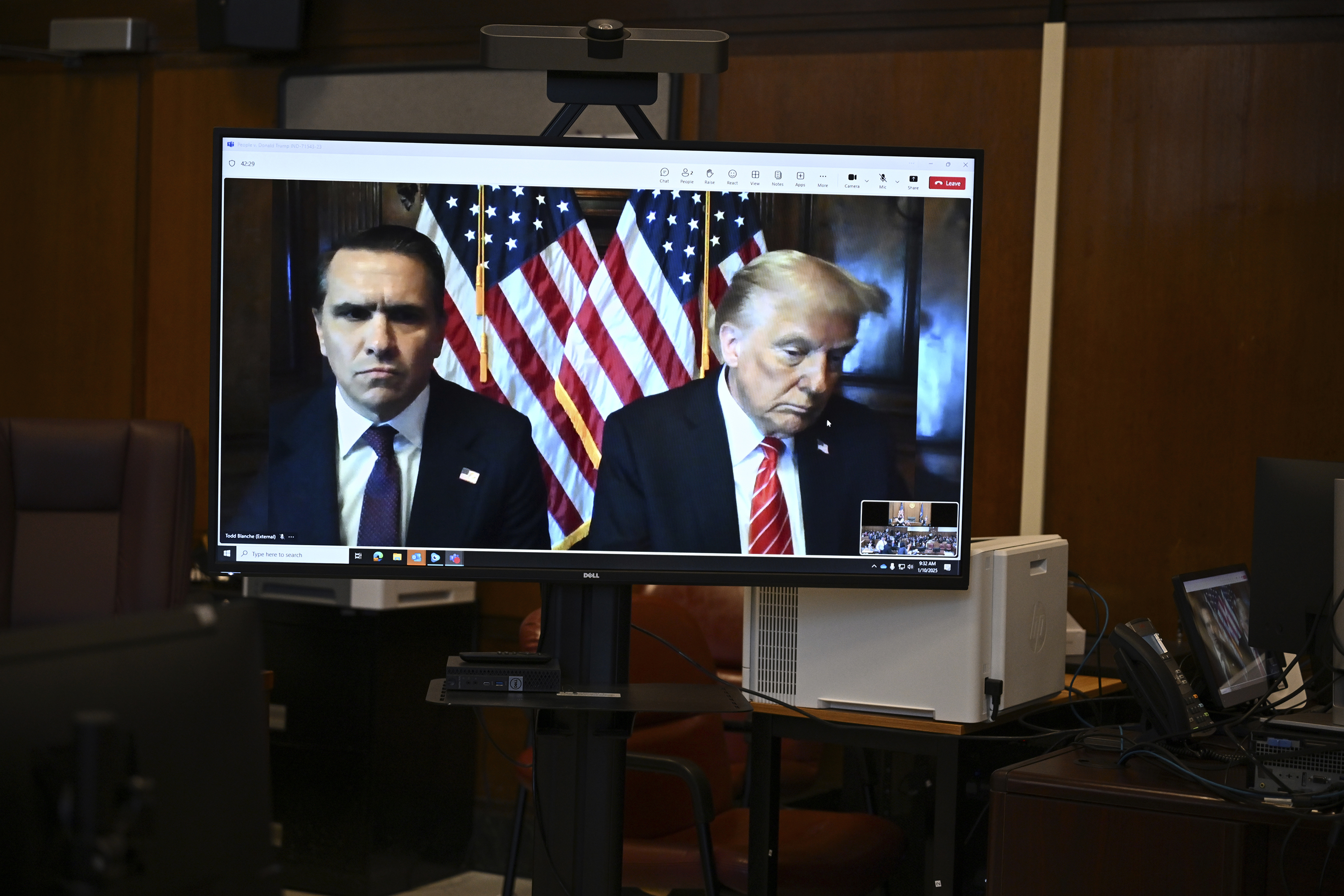 Attorney Todd Blanche and President-elect Donald Trump, seen on a television screen, appear virtually for sentencing for Trump's hush money conviction in a Manhattan courtroom on Friday, Jan. 10, 2025 in New York. (Angela Weiss/Pool Photo via AP)