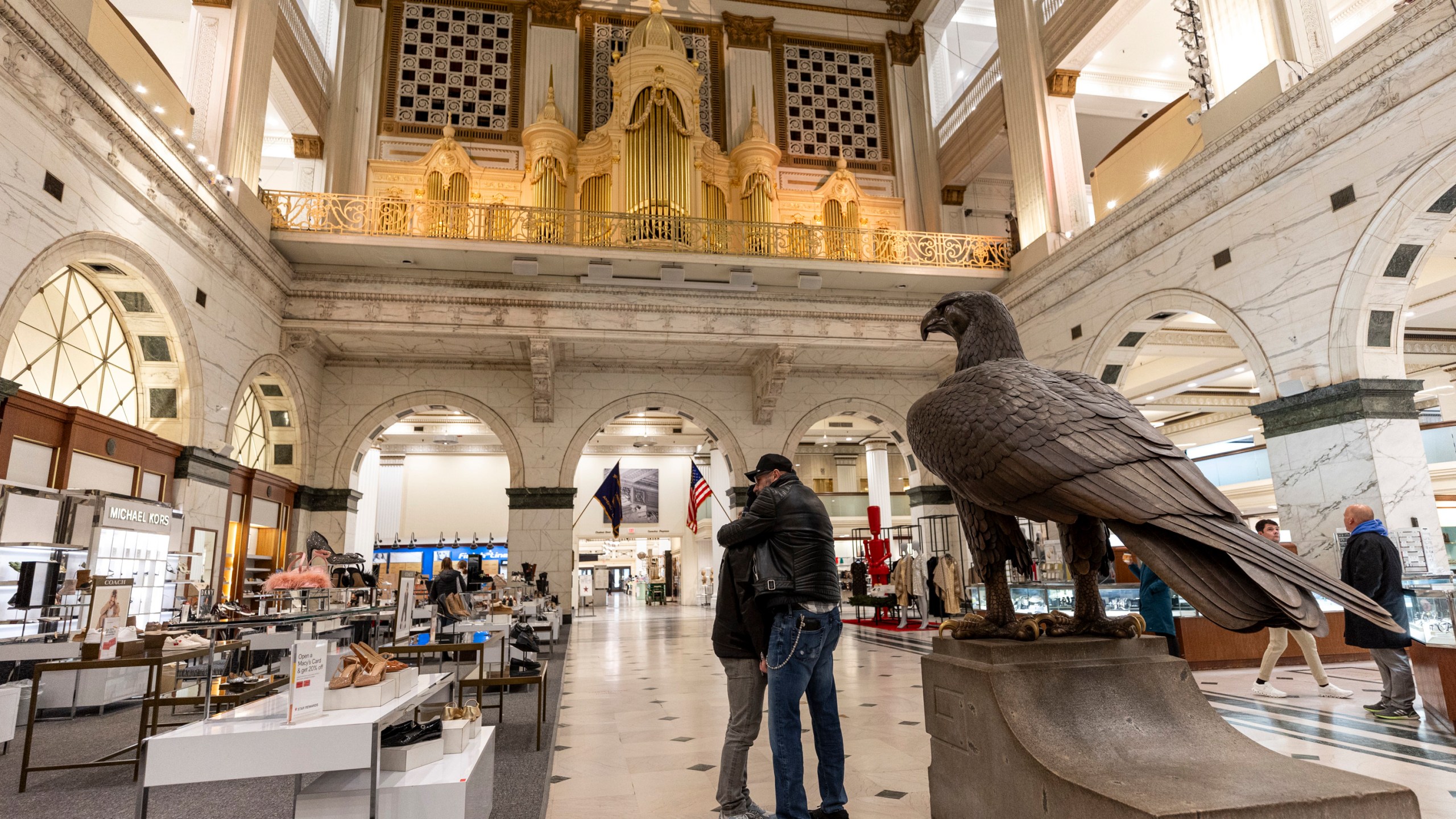 Bob Koherr, 64, and Walter Batt, 62, of Center City, Pa., share a moment together due to the closing of the Macy's and memories of their time spent together as the Wanamaker Organ, Friday, Jan. 10, 2025, in Philadelphia. (Tyger Williams/The Philadelphia Inquirer via AP)