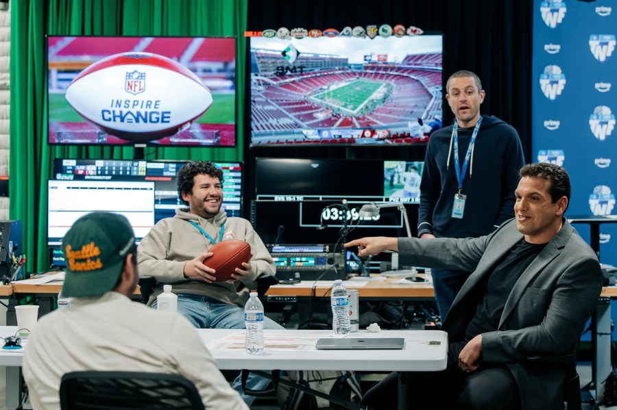 IN this image provided by Amazon Prime Video, from left, Prime Video Senior Coordinating Producer Alex Strand; Keegan Abdoo of the NFL’s Next Gen Stats Department; Scott Karpen, Producer of “Prime Vision with Next Gen Stats”; and Prime Video “Thursday Night Football” analytics expert Sam Schwartzstein talk at the Amazon/MGM Studios in Culver City, Calif., Thursday, Dec 12, 2024, , before the Los Angeles Rams-San Francisco 49ers NFL football game. (Timothy Buckman/Amazon Prime Video via AP)