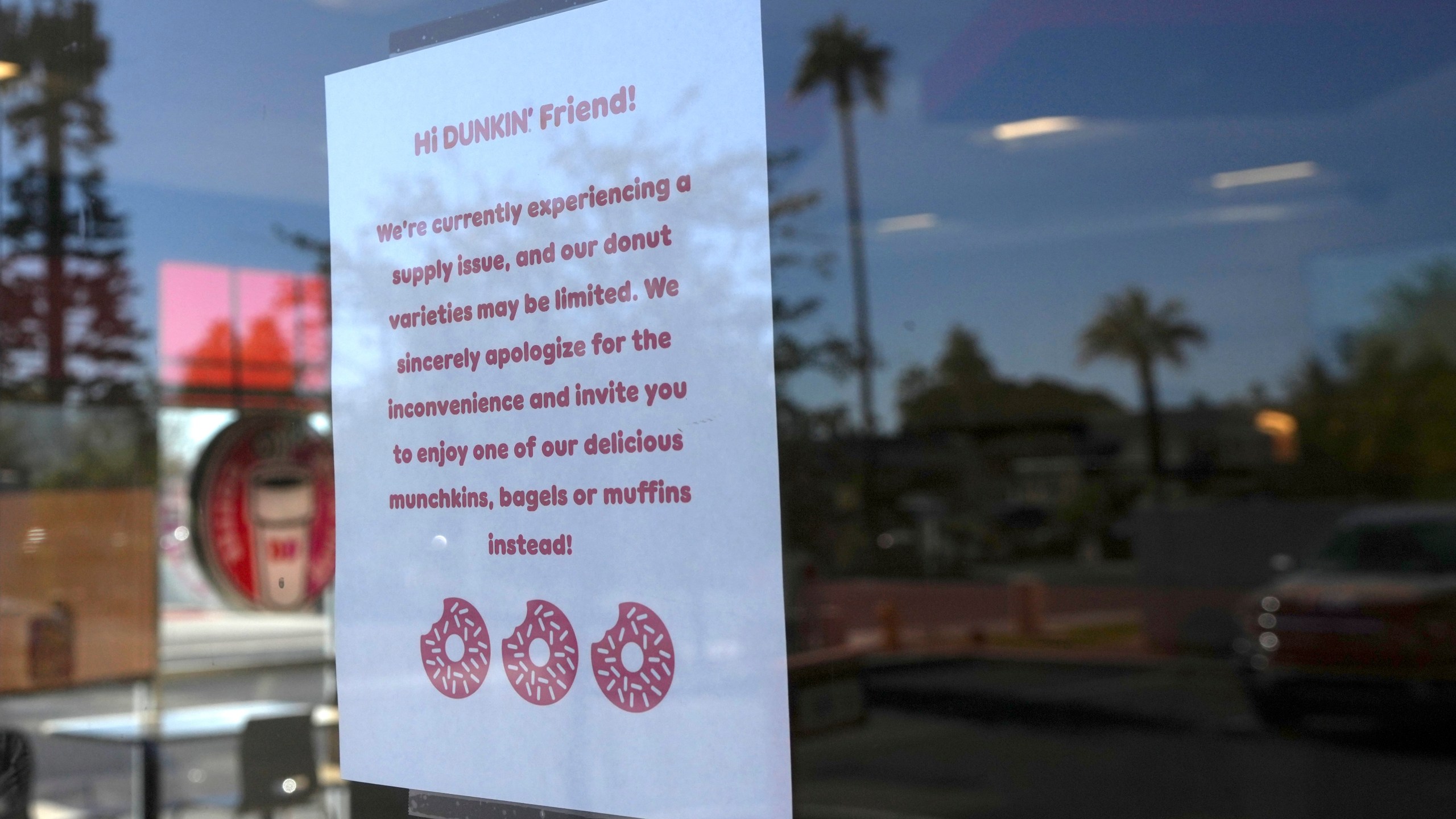 A sign on the door of a Dunkin' Donuts restaurant explains that customers will find limited doughnut selections for sale Friday, Jan. 10, 2025, in Tempe, Ariz. (AP Photo/Ross D. Franklin)