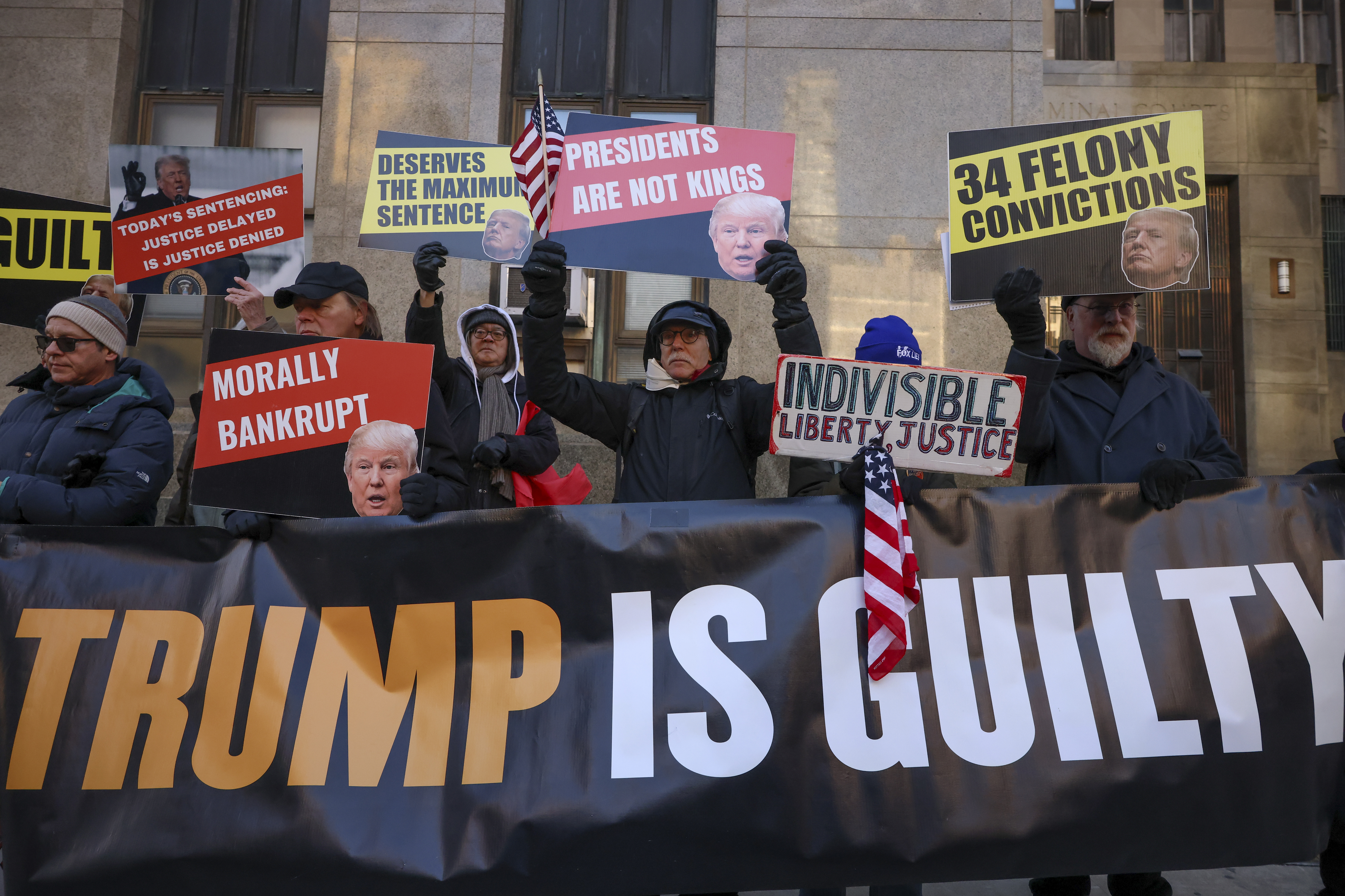 Demonstrators protest outside Manhattan criminal court before the start of the sentencing in President-elect Donald Trump's hush money case, Friday, Jan. 10, 2025, in New York. (AP Photo/Yuki Iwamura)