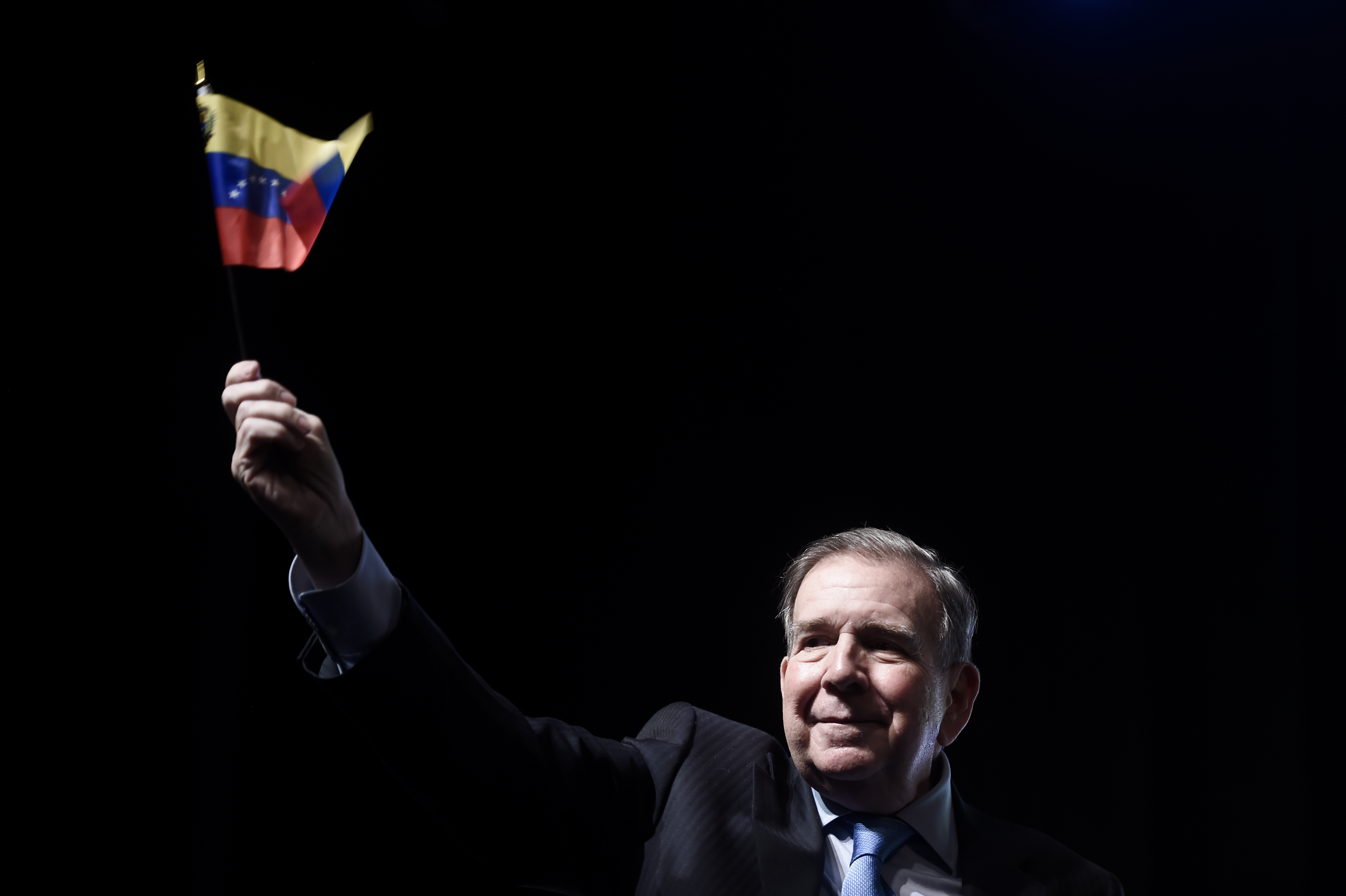 Venezuela's opposition leader Edmundo Gonzalez, who has been recognized by several governments including the U.S. as Venezuela's president-elect, waves a Venezuelan flag during a meeting with supporters in Panama City, Jan. 8, 2025, two days ahead of Maduro's inauguration ceremony where he will be sworn in for a third term. (AP Photo/Agustin Herrera)