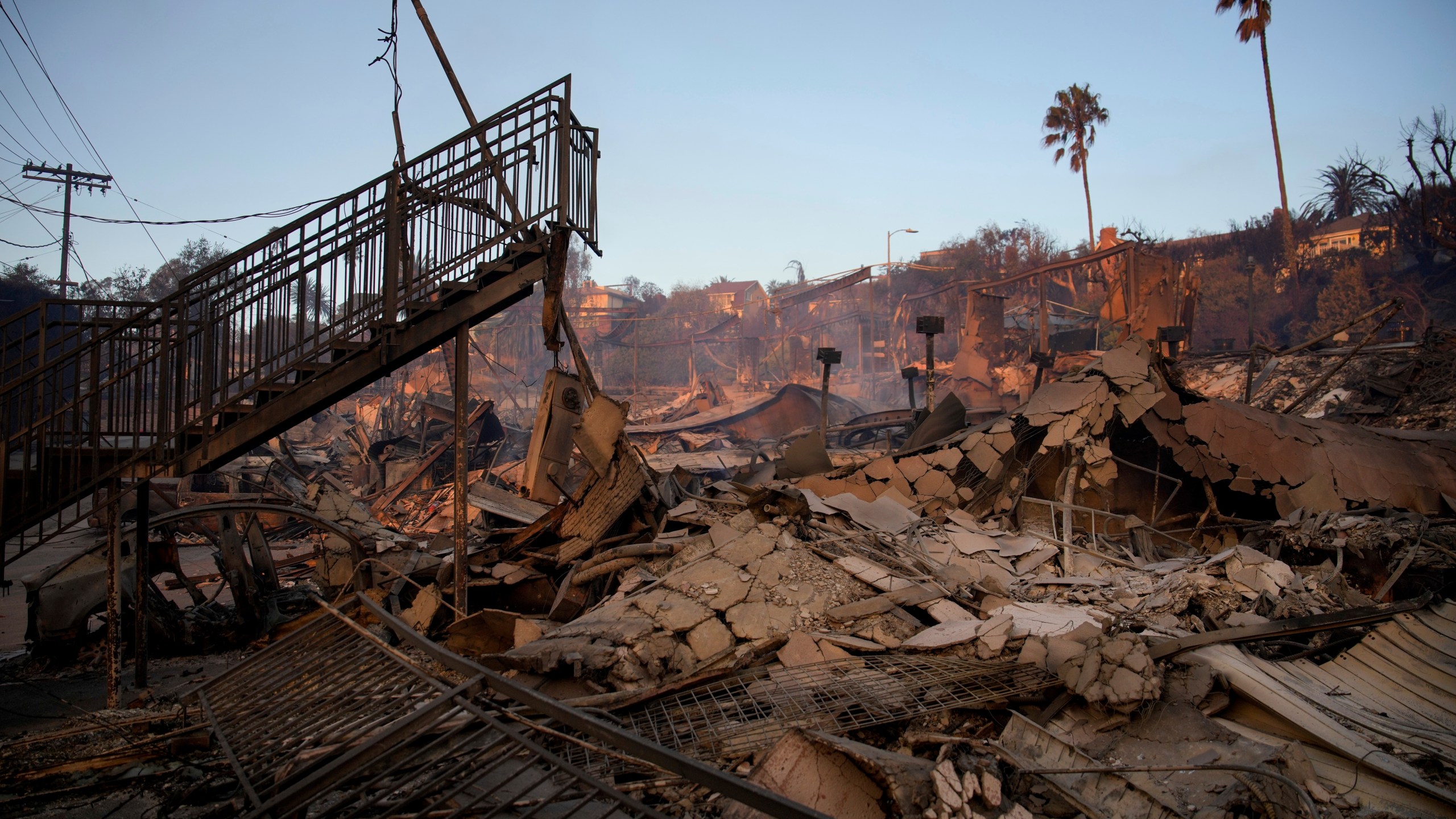 A staircase is left partially standing in a property in the aftermath of the Palisades Fire in the Pacific Palisades neighborhood of Los Angeles, Friday, Jan. 10, 2025. (AP Photo/John Locher)