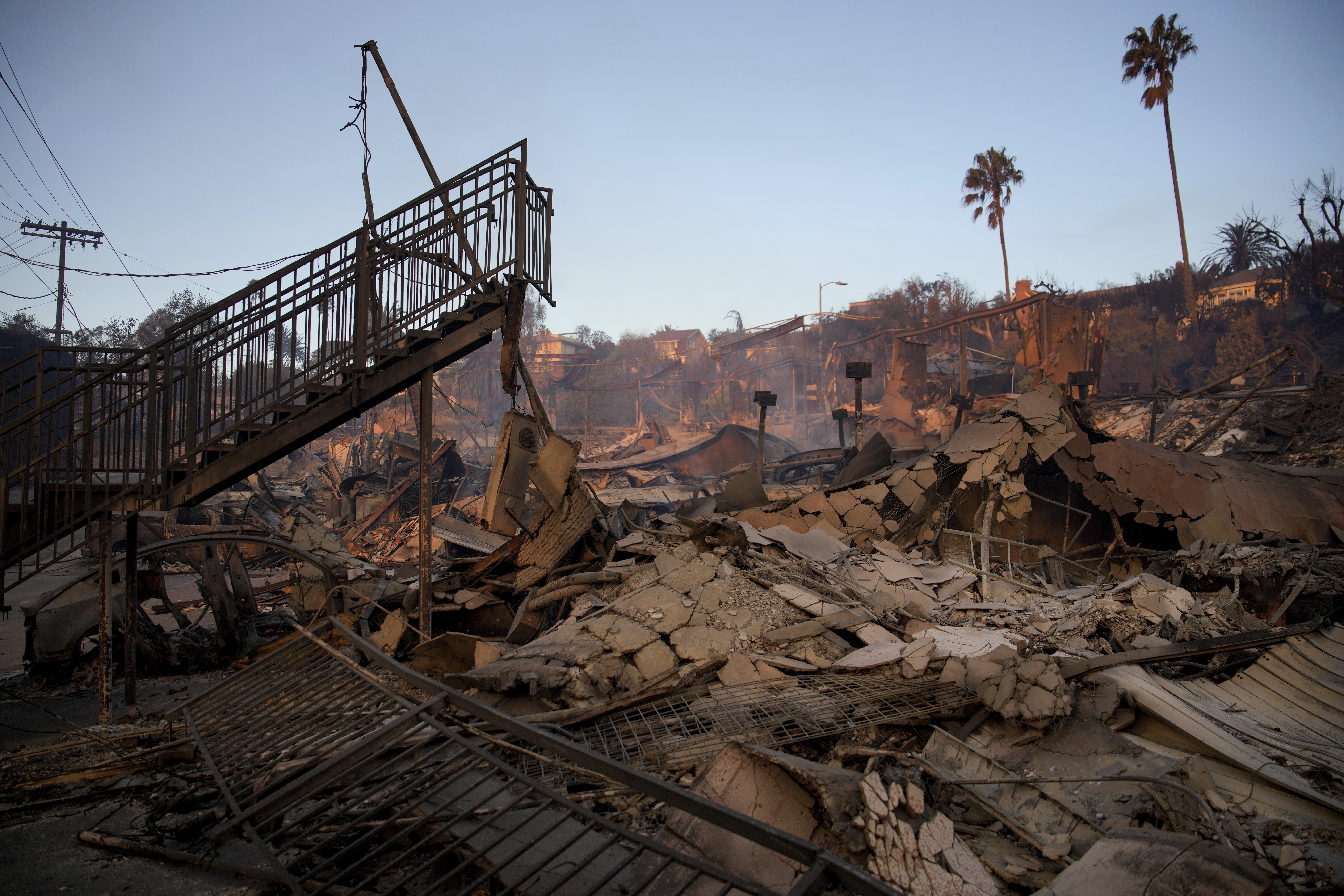 A staircase is left partially standing in a property in the aftermath of the Palisades Fire in the Pacific Palisades neighborhood of Los Angeles, Friday, Jan. 10, 2025. (AP Photo/John Locher)