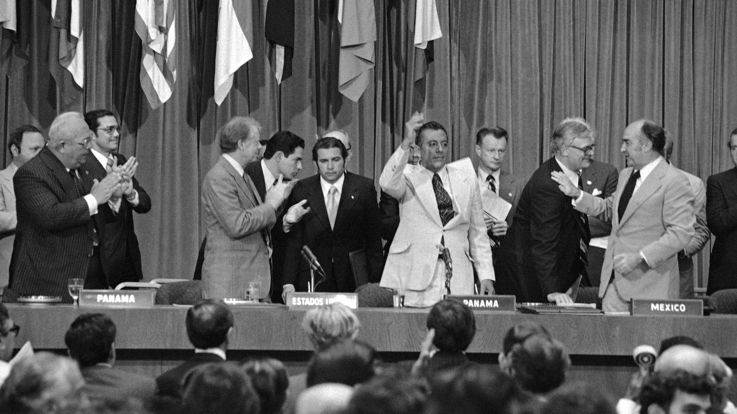 FILE - President Jimmy Carter applauds and General Omar Torrijos waves after the signing and exchange of treaties in Panama City on June 16, 1978, giving control of the Panama Canal to Panama in 2000. At far right is Zbigniew Brzezinski, Carterís National Security Advisor. (AP Photo, File)