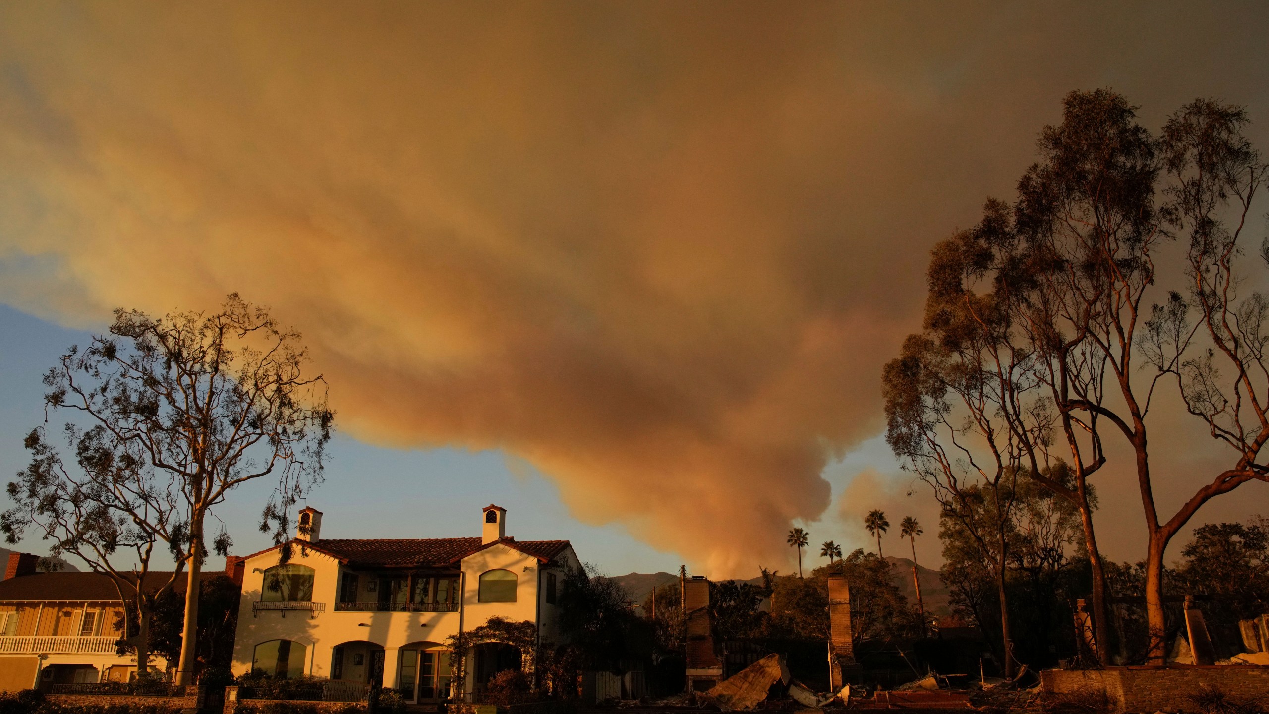 A plume of smoke rises from the Palisades Fire on Friday, Jan. 10, 2025, in the Pacific Palisades section of Los Angeles. (AP Photo/John Locher)