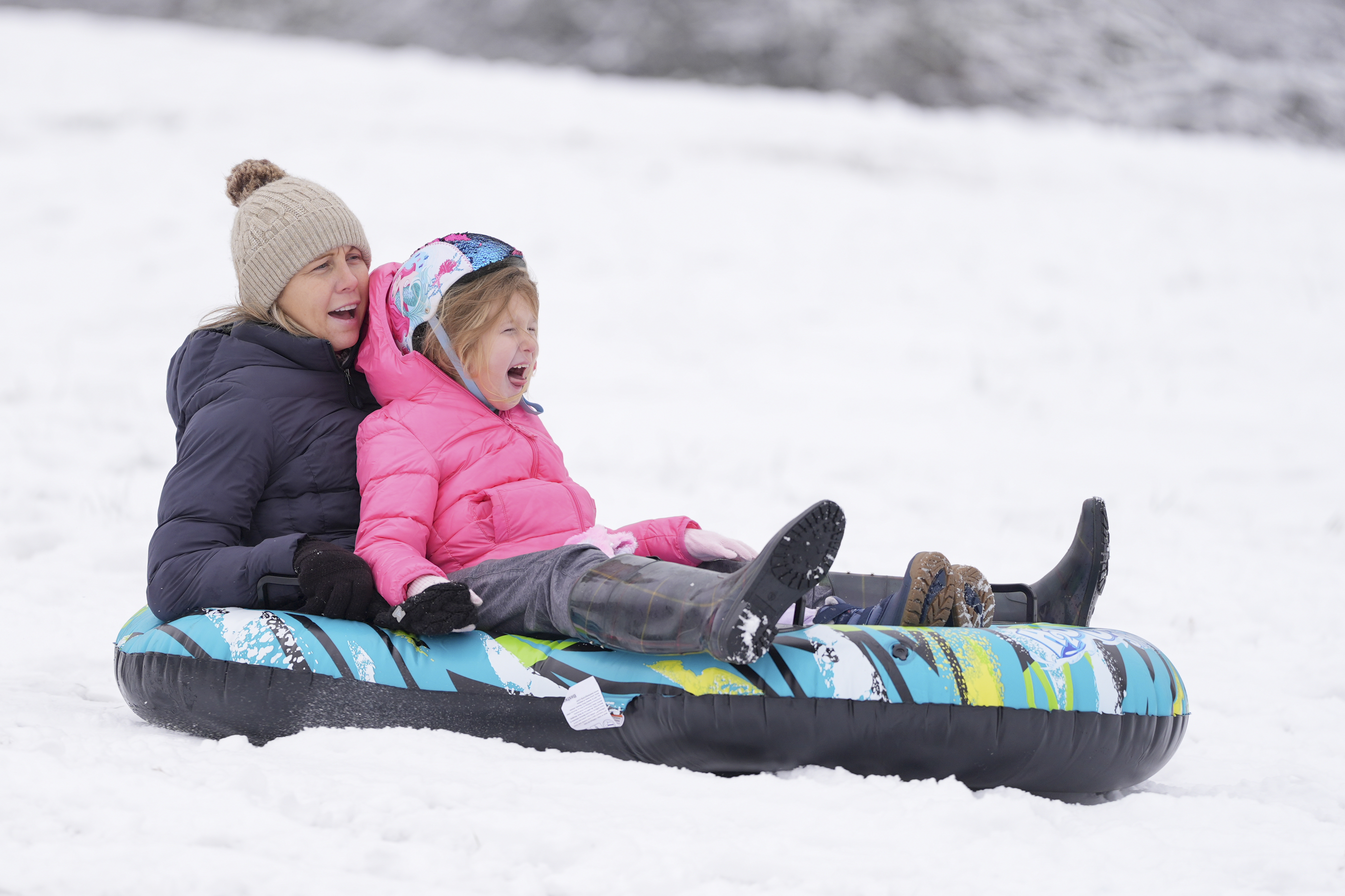 People sled down a snow covered hill Saturday, Jan. 11, 2025, in Nashville, Tenn. (AP Photo/George Walker IV)