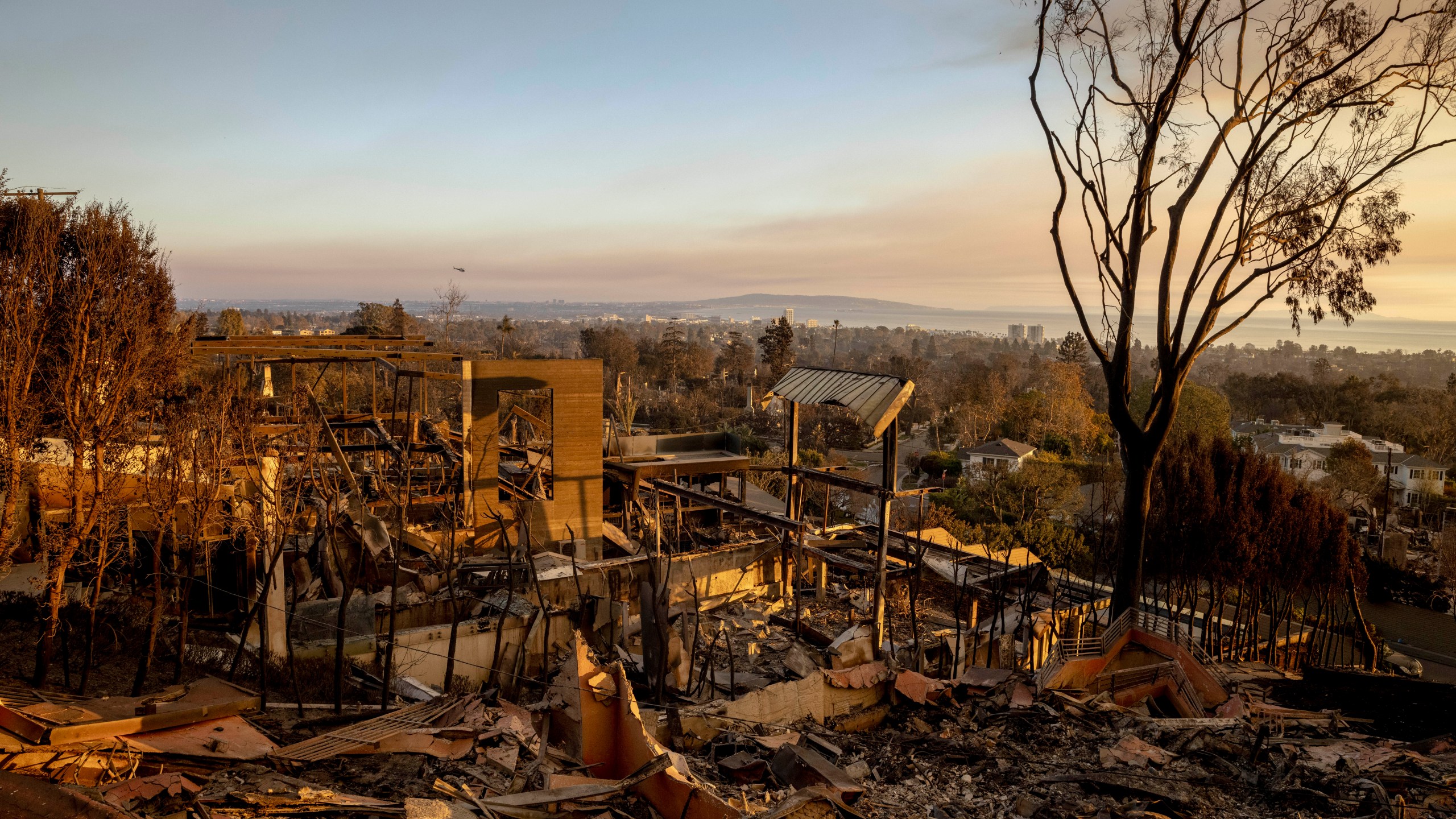 A home destroyed by the Palisades Fire is seen during sunset in Pacific Palisades, Calif., Friday, Jan. 10, 2025. (Stephen Lam/San Francisco Chronicle via AP)