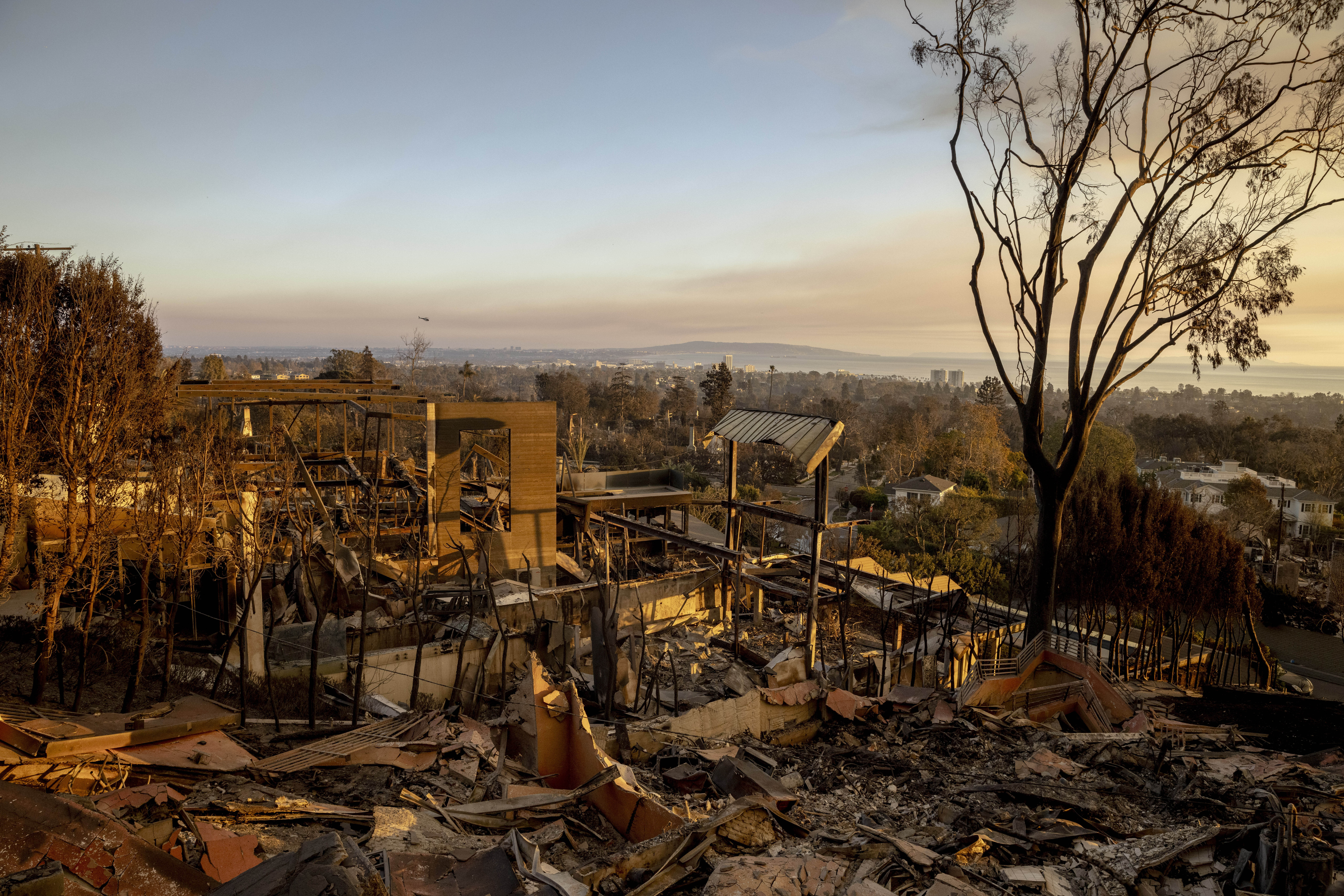 A home destroyed by the Palisades Fire is seen during sunset in Pacific Palisades, Calif., Friday, Jan. 10, 2025. (Stephen Lam/San Francisco Chronicle via AP)