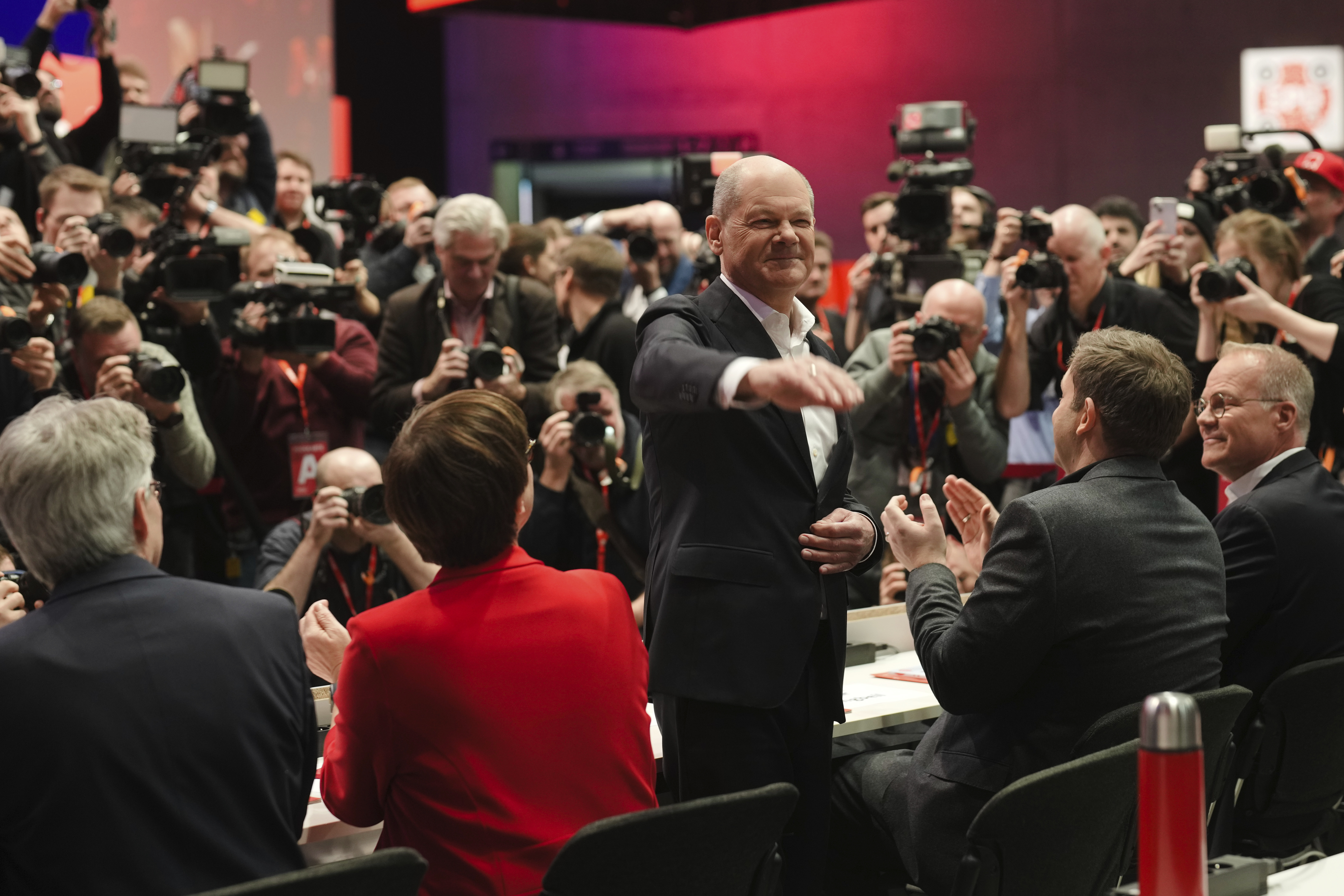 German Chancellor Olaf Scholz, center, waves as he arrives at a special party convention of the Social Democratic Party, SPD, in Berlin, Germany, Saturday, Jan. 11, 2025. (AP Photo/Markus Schreiber)