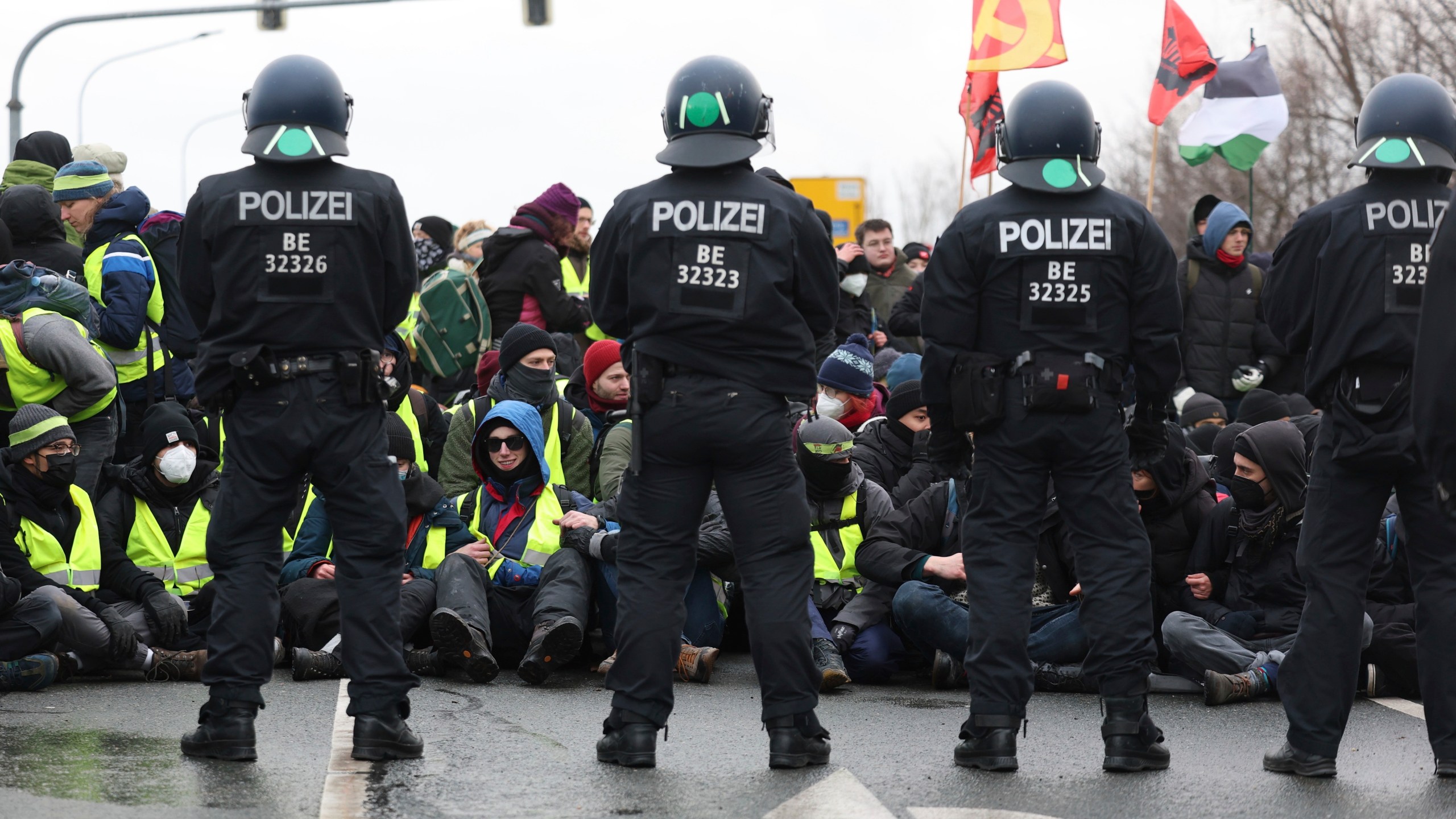 Police officers stand guard during a demonstration ahead of the AfD's national party conference, in Riesa, Germany, Saturday, Jan. 11, 2025. (Jan Woitas/dpa via AP)