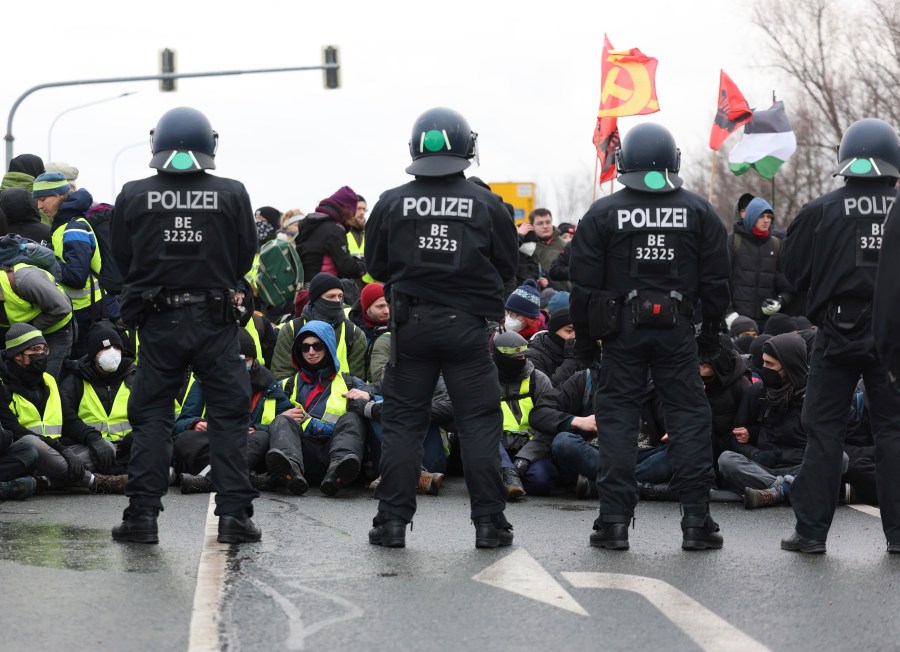 Police officers stand guard during a demonstration ahead of the AfD's national party conference, in Riesa, Germany, Saturday, Jan. 11, 2025. (Jan Woitas/dpa via AP)