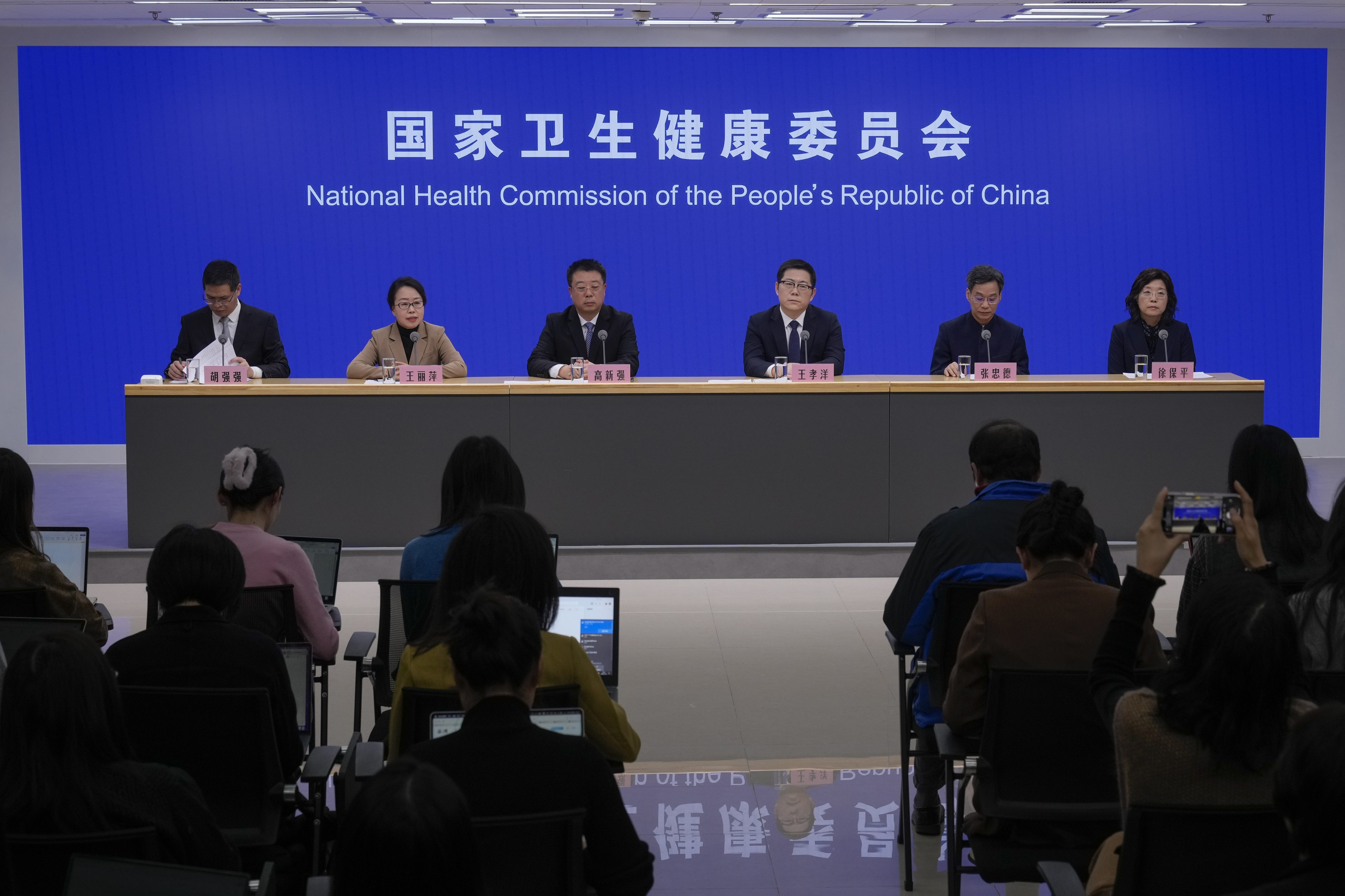 Wang Liping, second left, a researcher for the Chinese Center for Disease Control and Prevention speaks during a press briefing by the National Health Commission as concerns surfaced in recent days over a surge in HMPV infections in northern China after images circulated online of hospitals overrun with masked patients, in Beijing, Sunday, Jan. 12, 2025. (AP Photo/Andy Wong)