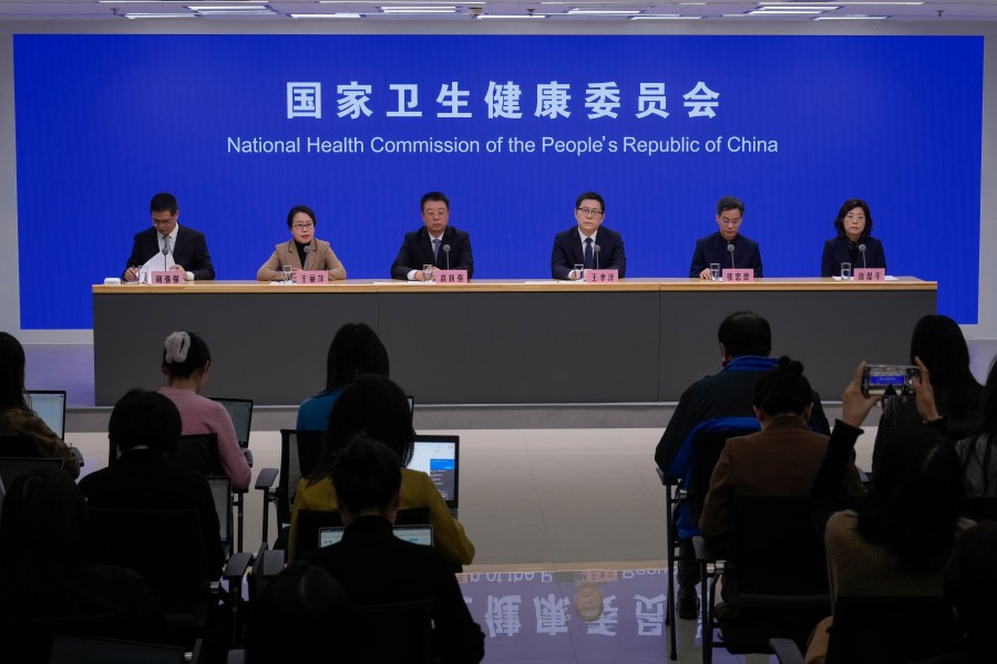 Wang Liping, second left, a researcher for the Chinese Center for Disease Control and Prevention speaks during a press briefing by the National Health Commission as concerns surfaced in recent days over a surge in HMPV infections in northern China after images circulated online of hospitals overrun with masked patients, in Beijing, Sunday, Jan. 12, 2025. (AP Photo/Andy Wong)