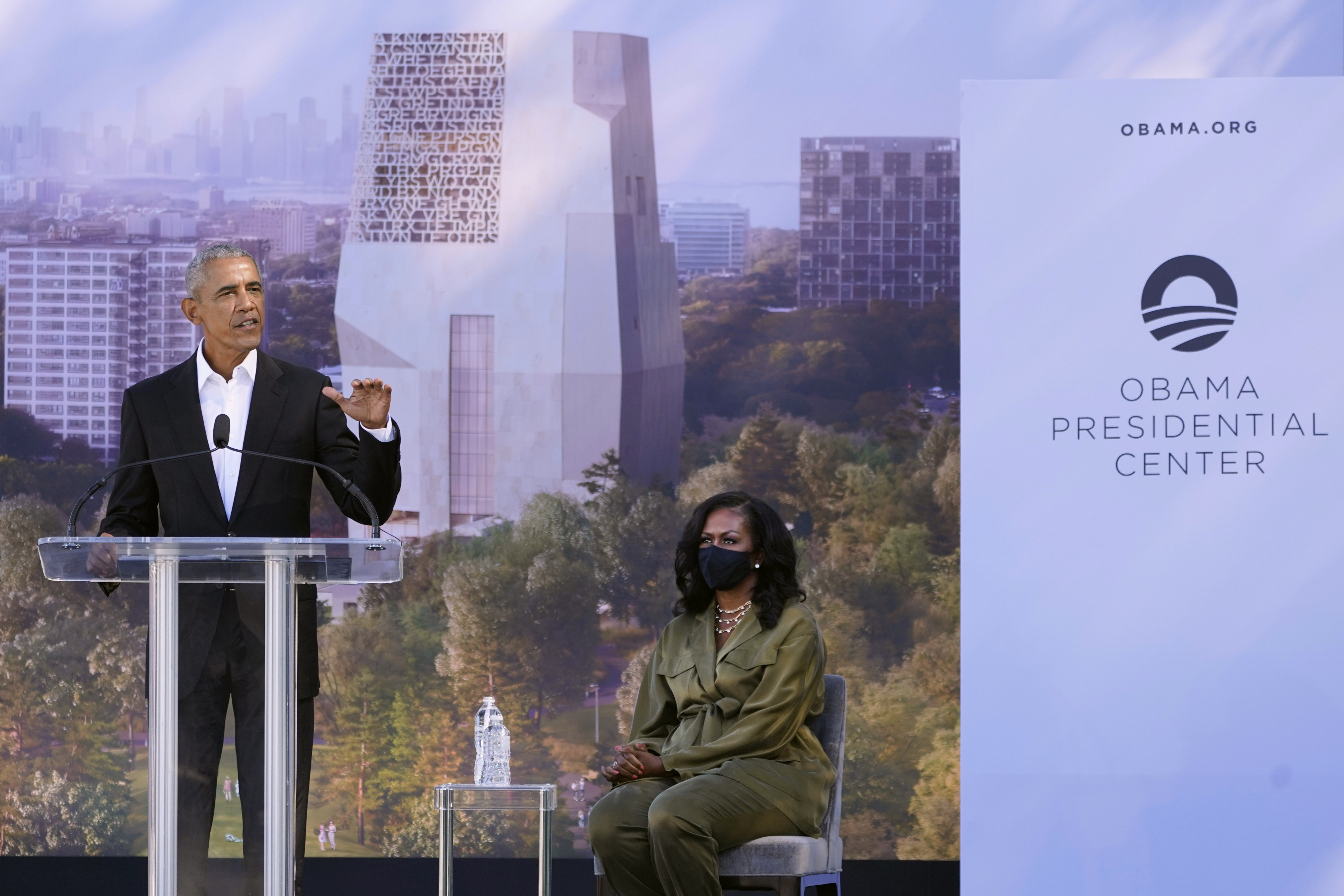 FILE - Former President Barack Obama speaks as former first lady Michelle Obama listens during a groundbreaking ceremony for the Obama Presidential Center, Sept. 28, 2021, in Chicago. (AP Photo/Charles Rex Arbogast, File)