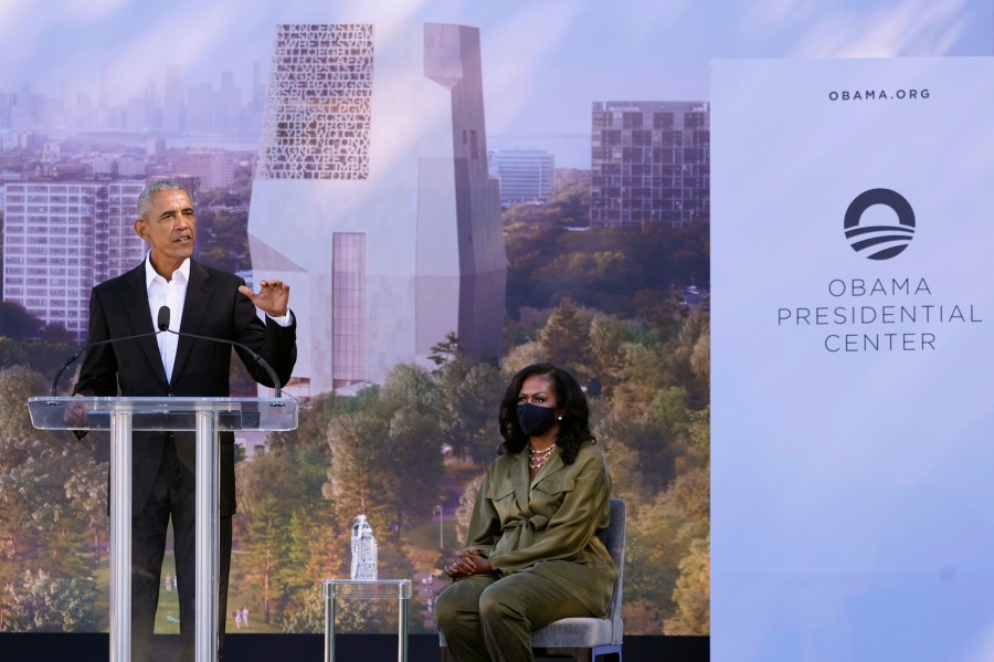 FILE - Former President Barack Obama speaks as former first lady Michelle Obama listens during a groundbreaking ceremony for the Obama Presidential Center, Sept. 28, 2021, in Chicago. (AP Photo/Charles Rex Arbogast, File)