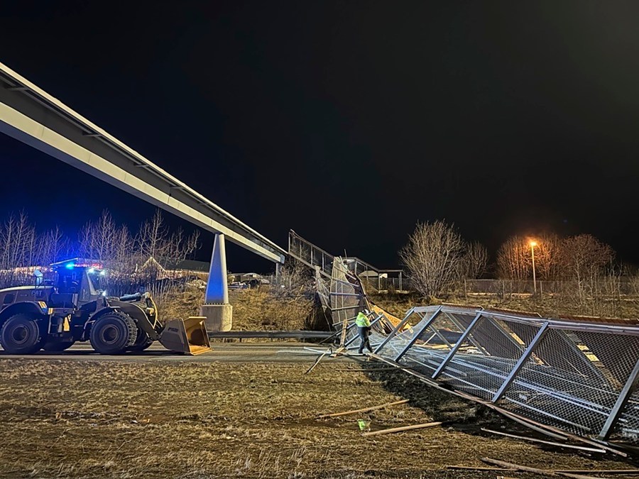 This image provided by the Alaska Department of Transportation & Public Facilities shows fencing and the roof of a walkway after collapsing onto the Seward Highway in Anchorage, Alaska, on Sunday, Jan. 12, 2025. (Alaska Department of Transportation & Public Facilities via AP)