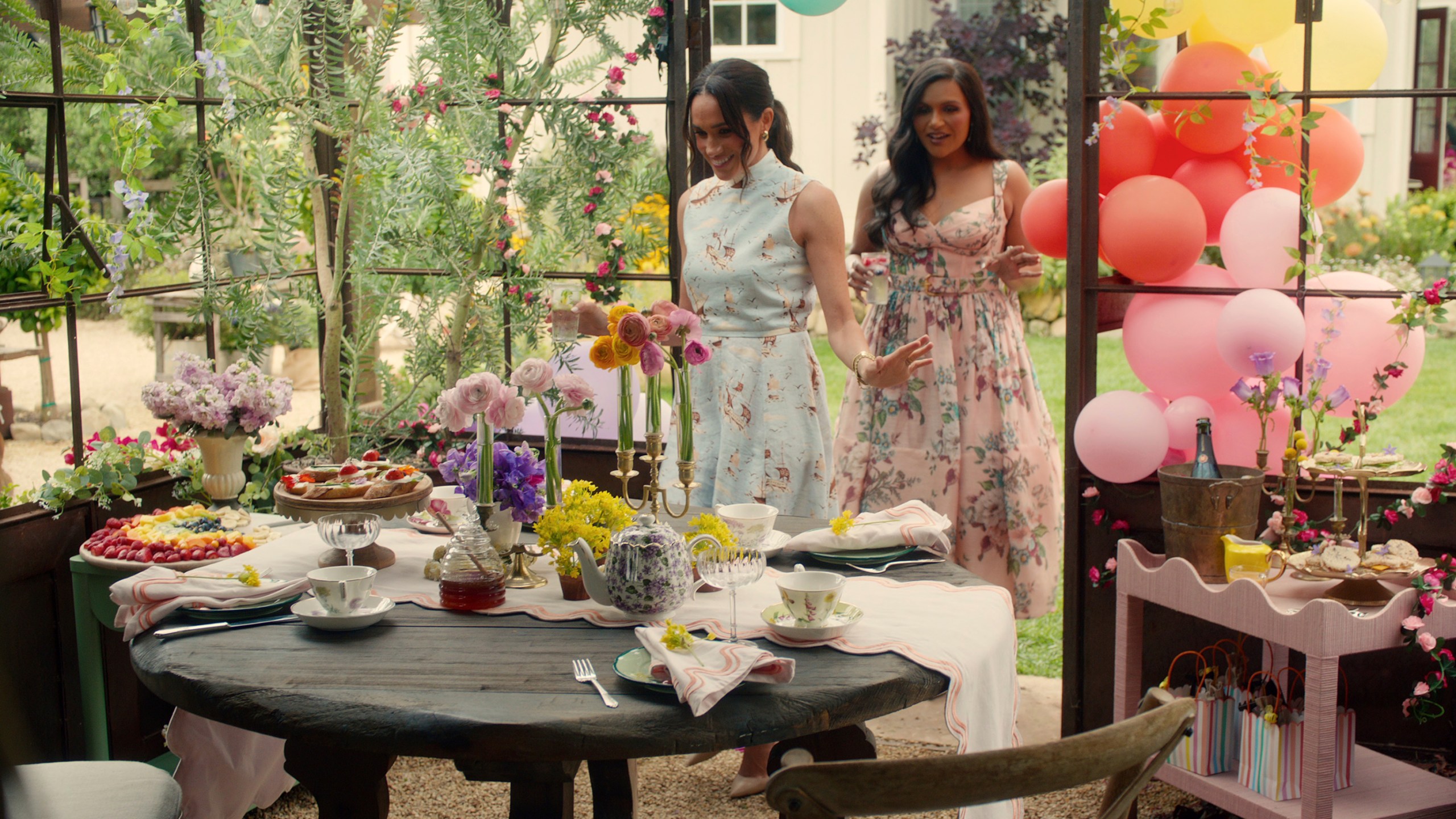 This image released by Netflix shows Meghan, Duchess of Sussex, and Mindy Kaling in a scene from her series "With Love, Meghan." (Netflix via AP)