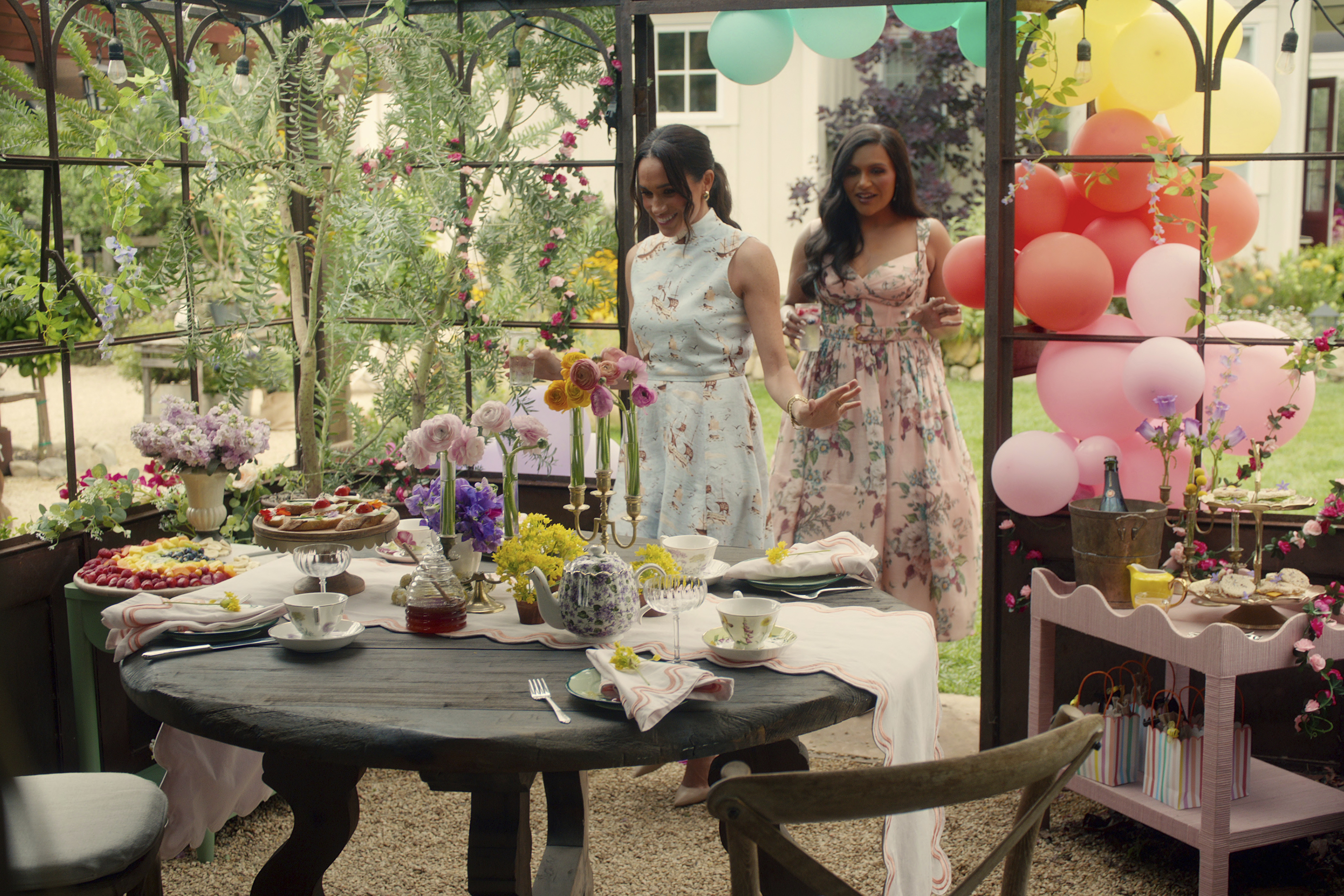 This image released by Netflix shows Meghan, Duchess of Sussex, and Mindy Kaling in a scene from her series "With Love, Meghan." (Netflix via AP)