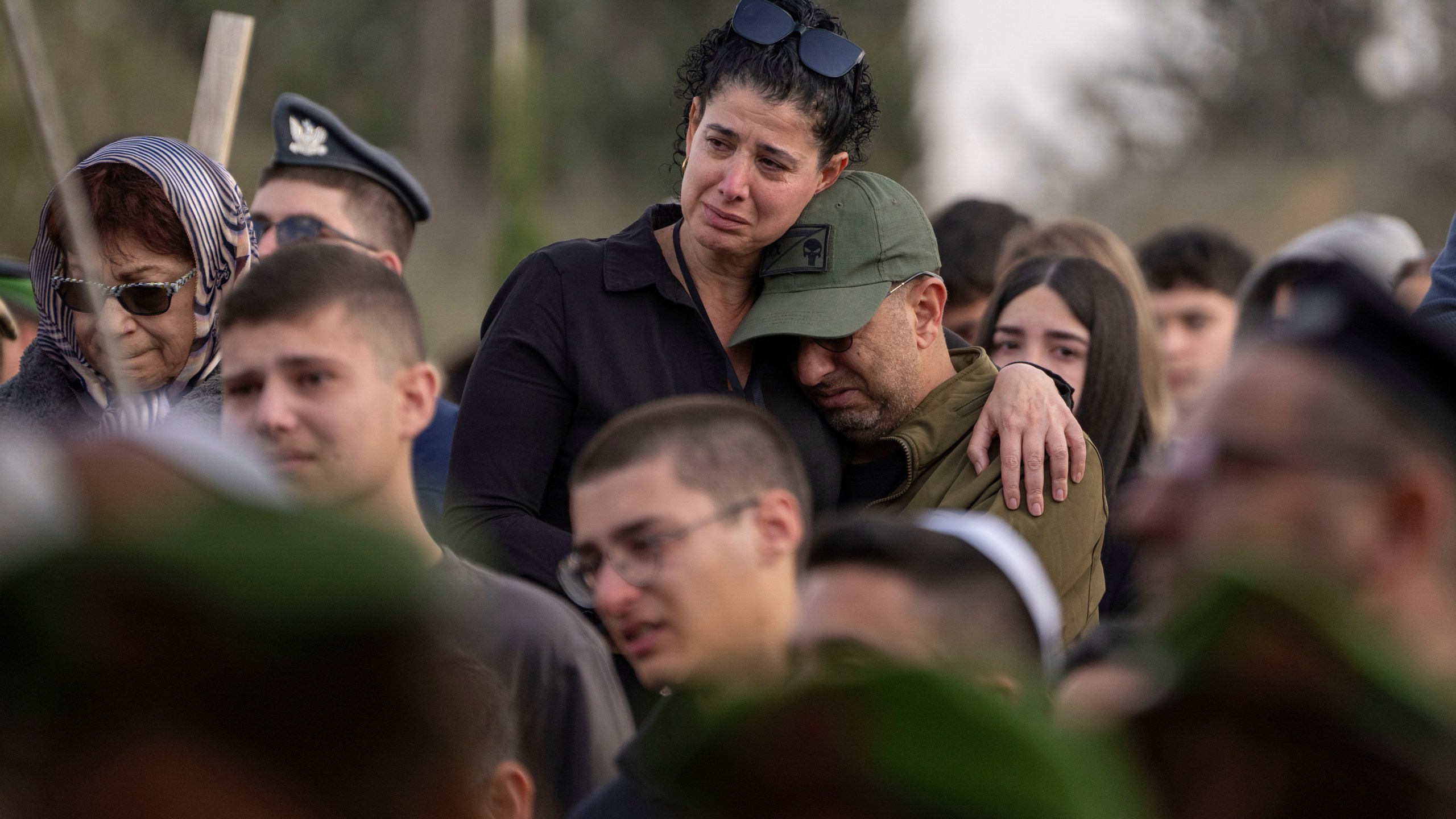 Mourners attend the funeral of Israeli soldier Sergeant Yahav Maayan who was killed in combat in the Gaza Strip, during his funeral at a military cemetery in Modiin, Israel, Sunday, Jan. 12, 2025. (AP Photo/Ohad Zwigenberg)