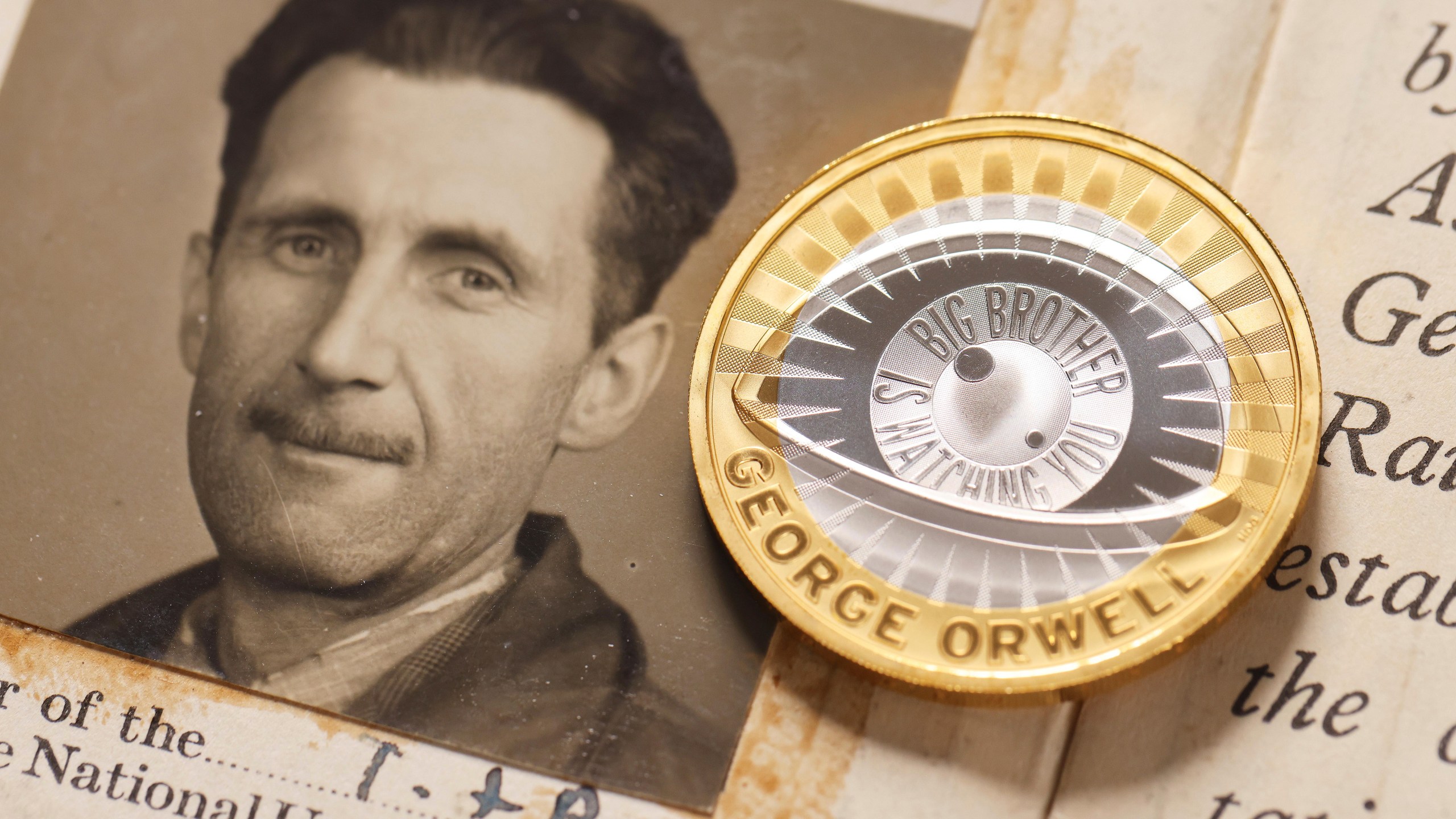 This photo, provided by The Royal Mint on Monday, Jan. 13, 2025, shows a portrait of George Orwell and a new £2 coin. (The Royal Mint/PinPep via AP)