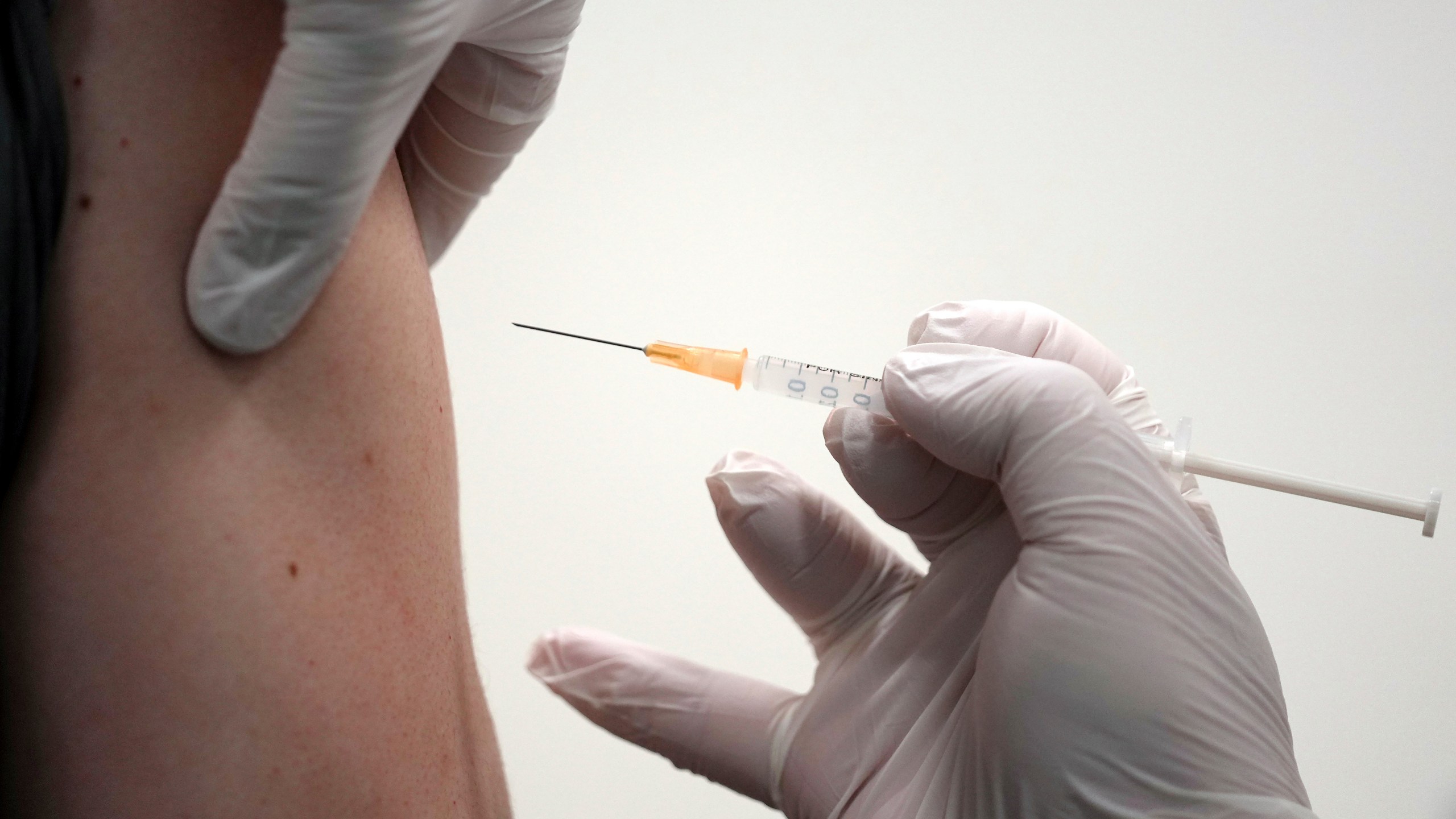 FILE - A local resident receives the Moderna COVID-19 vaccine shot at a center, June 30, 2021, in the Sumida ward of Tokyo. (AP Photo/Eugene Hoshiko, File)