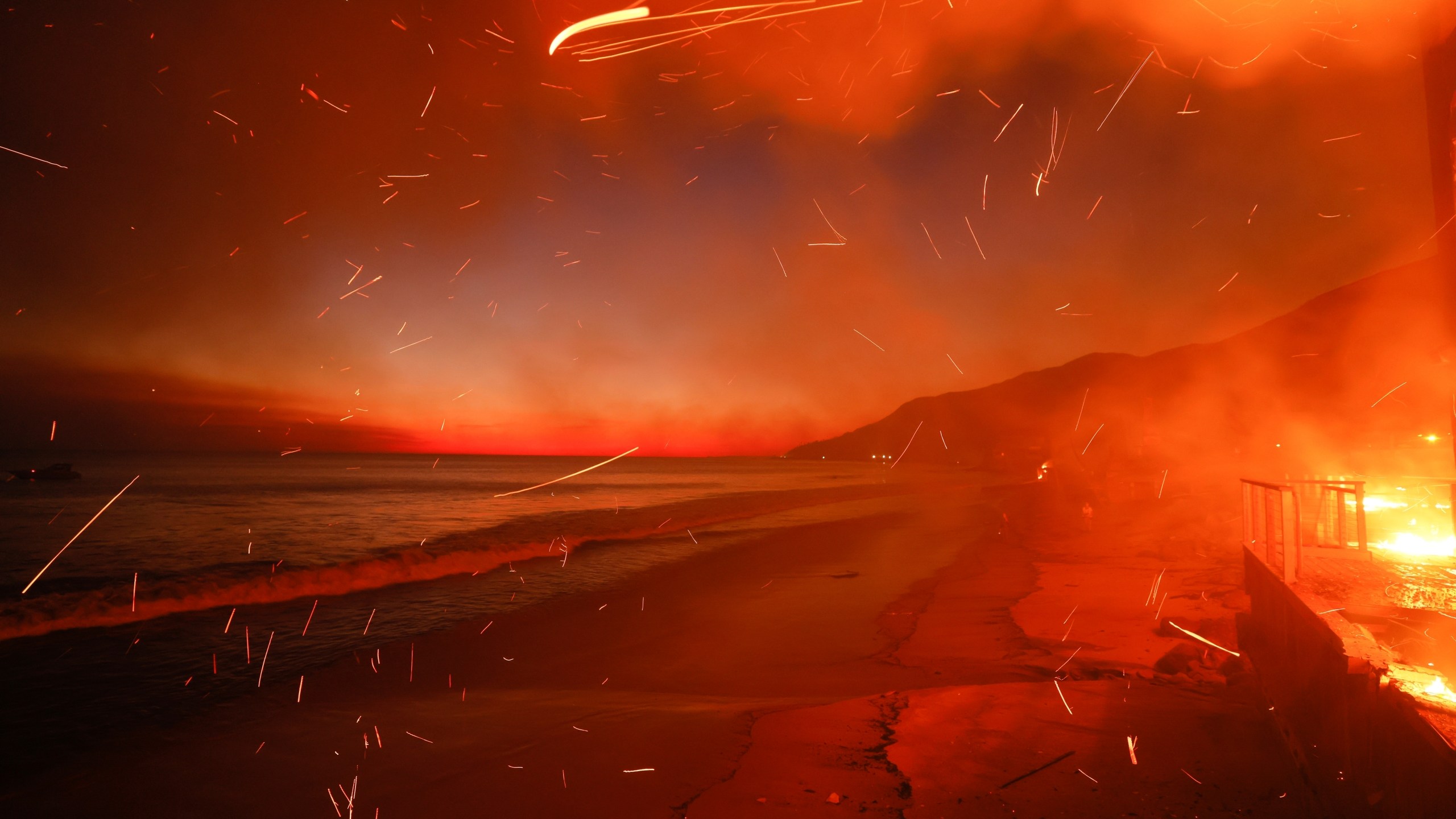 FILE - The Palisades Fire burns a beach front property, Jan. 8, 2025, in Malibu, Calif. (AP Photo/Etienne Laurent, File)