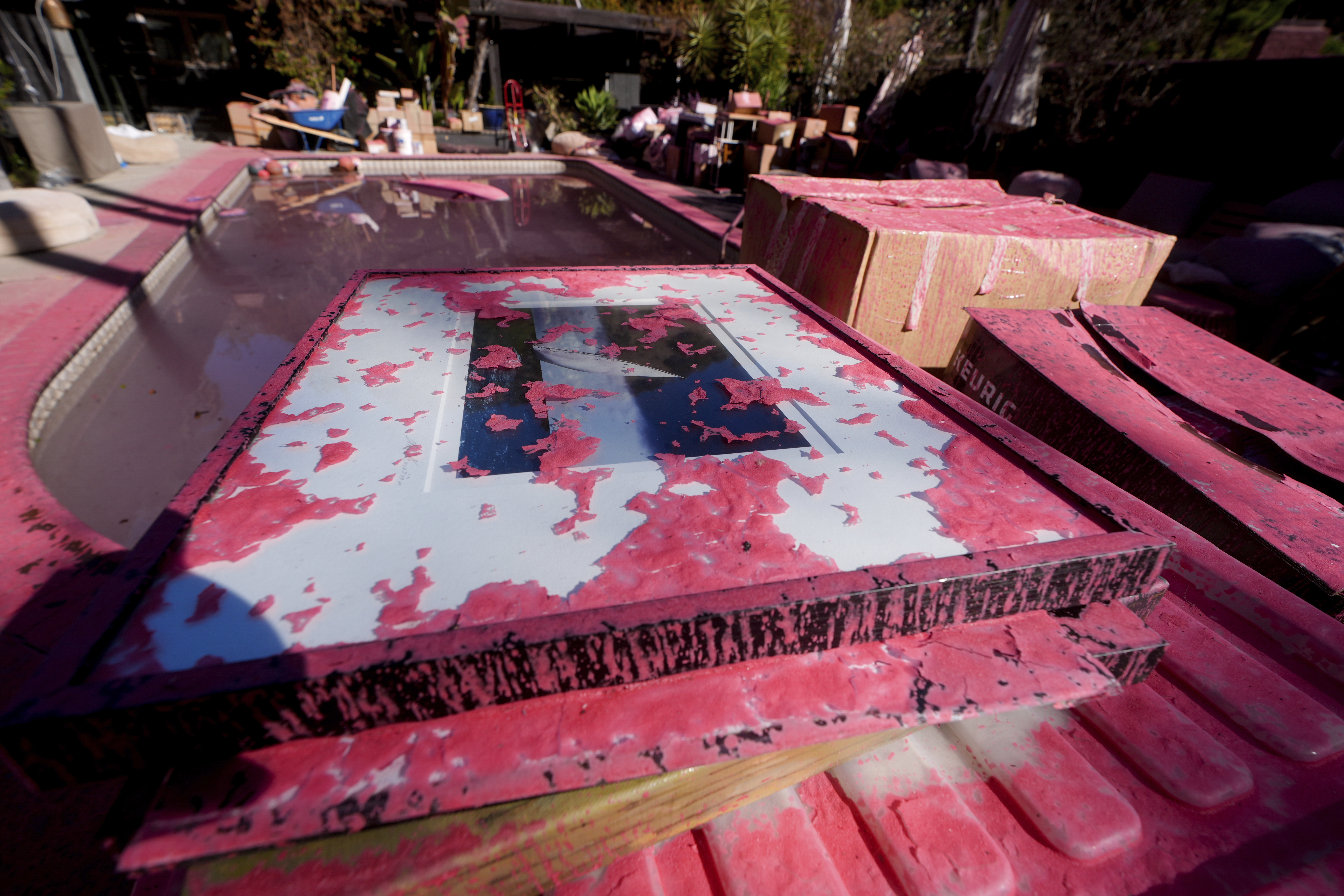 Retardant covers a framed photograph after crews battled the Palisades Fire in Mandeville Canyon Monday, Jan 13, 2025 in Los Angeles. (AP Photo/Richard Vogel)