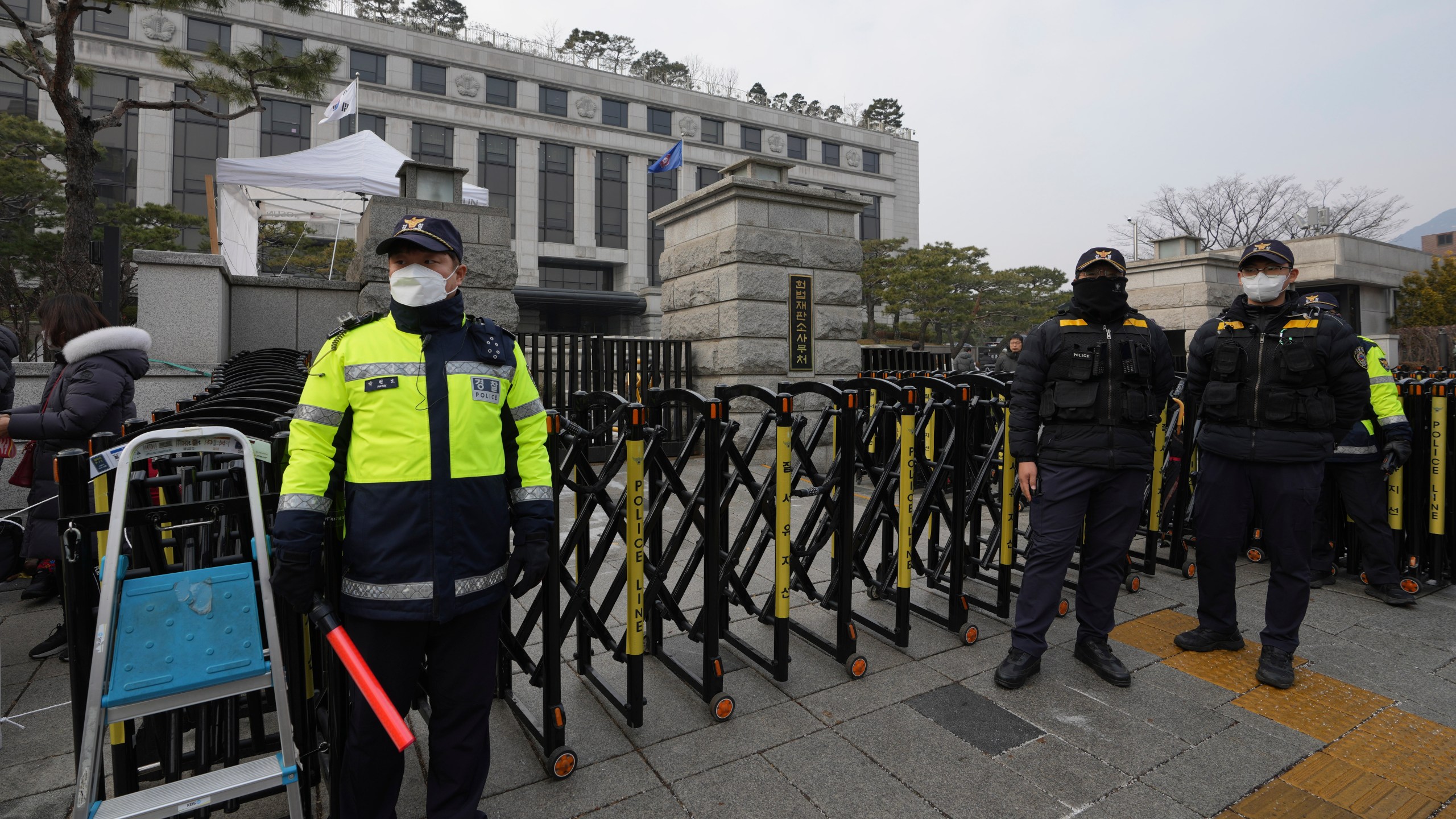 South Korean police officers stand in front of the Constitutional Court in Seoul, South Korea, Tuesday, Jan. 14, 2025. (AP Photo/Lee Jin-man)