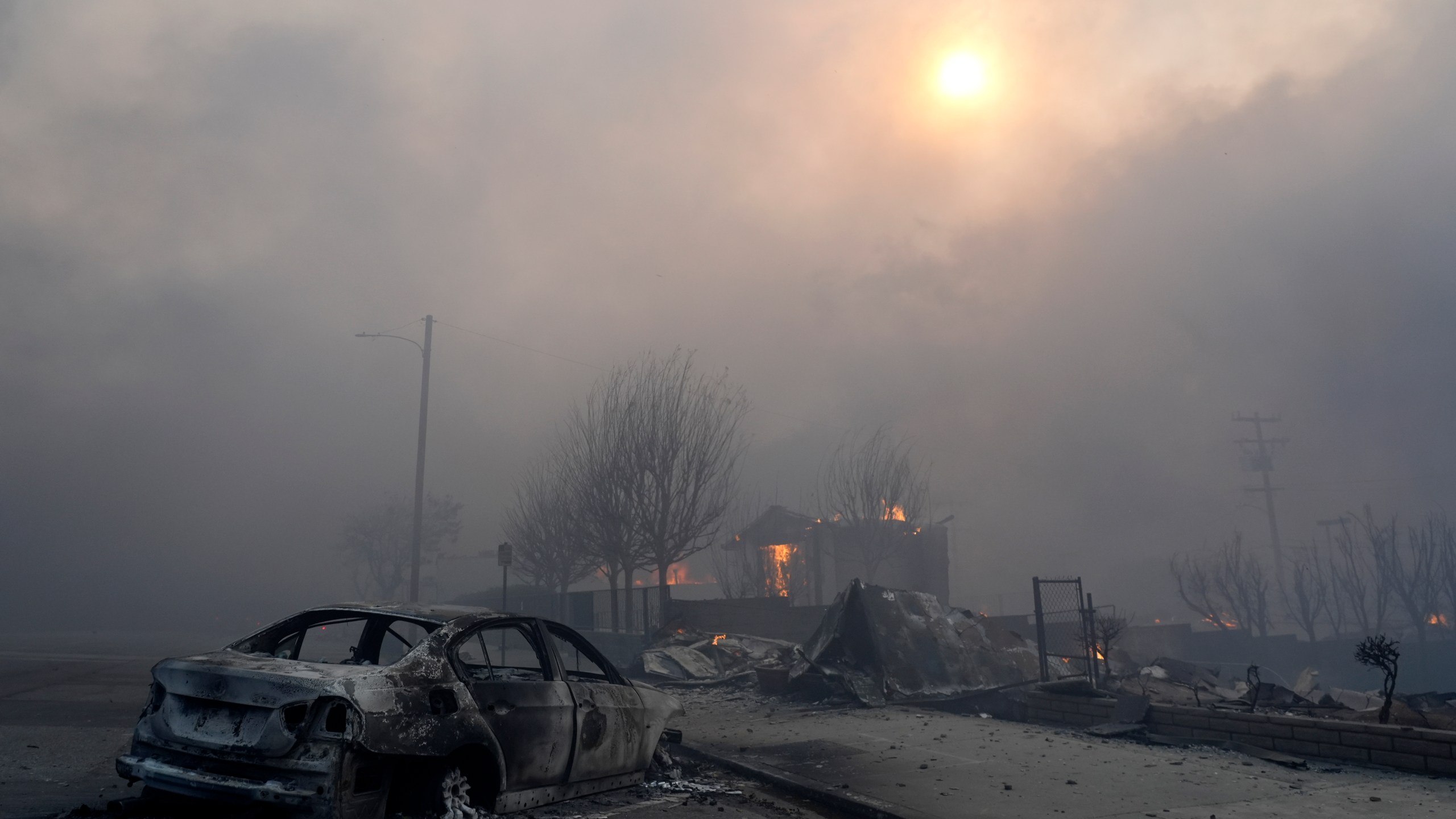 FILE - A burned-out car sits among rubble in the downtown Altadena section of Pasadena, Calif., Jan. 8, 2025. (AP Photo/Chris Pizzello, File)