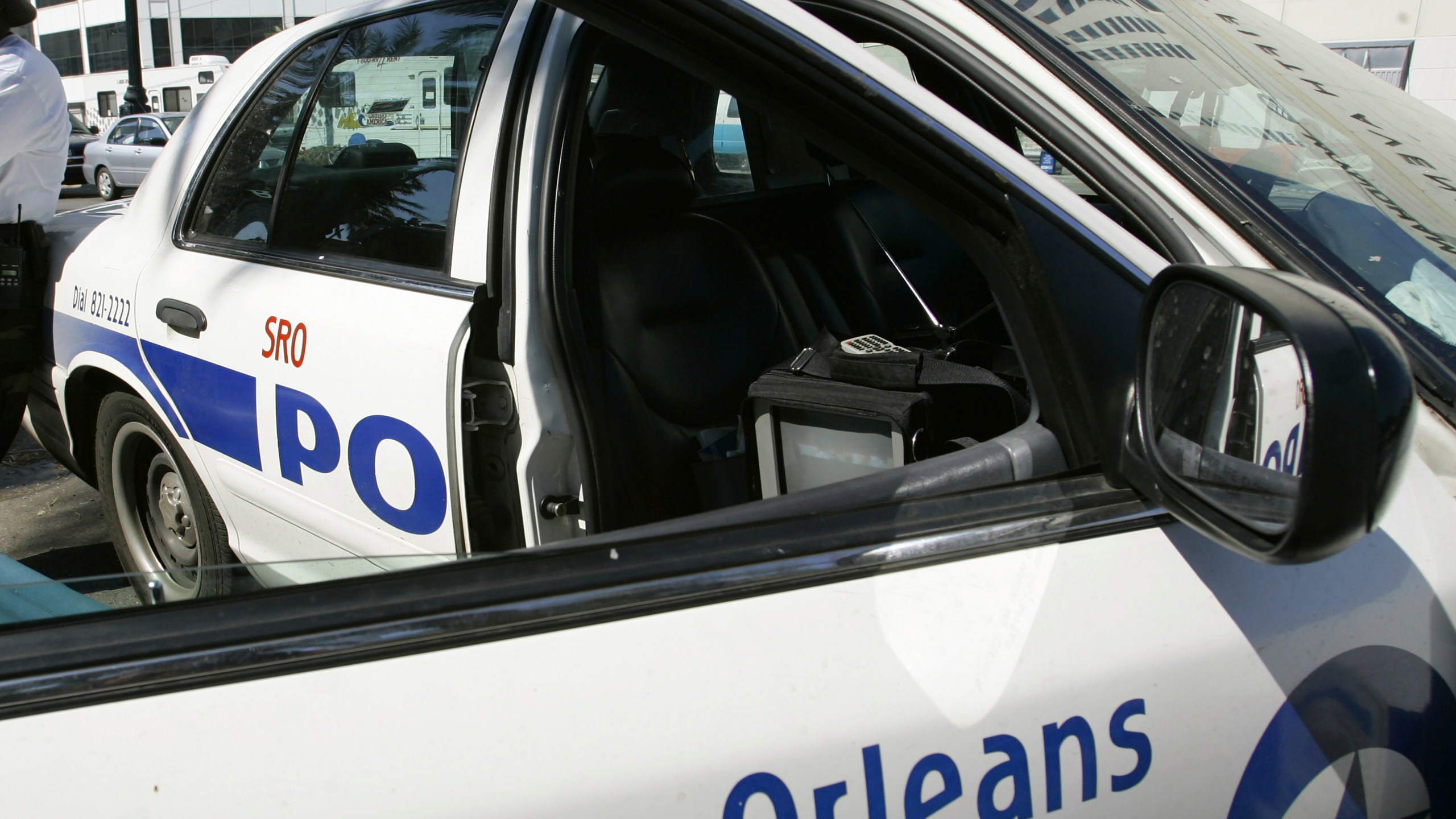 FILE - A New Orleans police officer leans against a patrol car, Sept. 11, 2005. (AP Photo/Anja Niedringhaus, file)