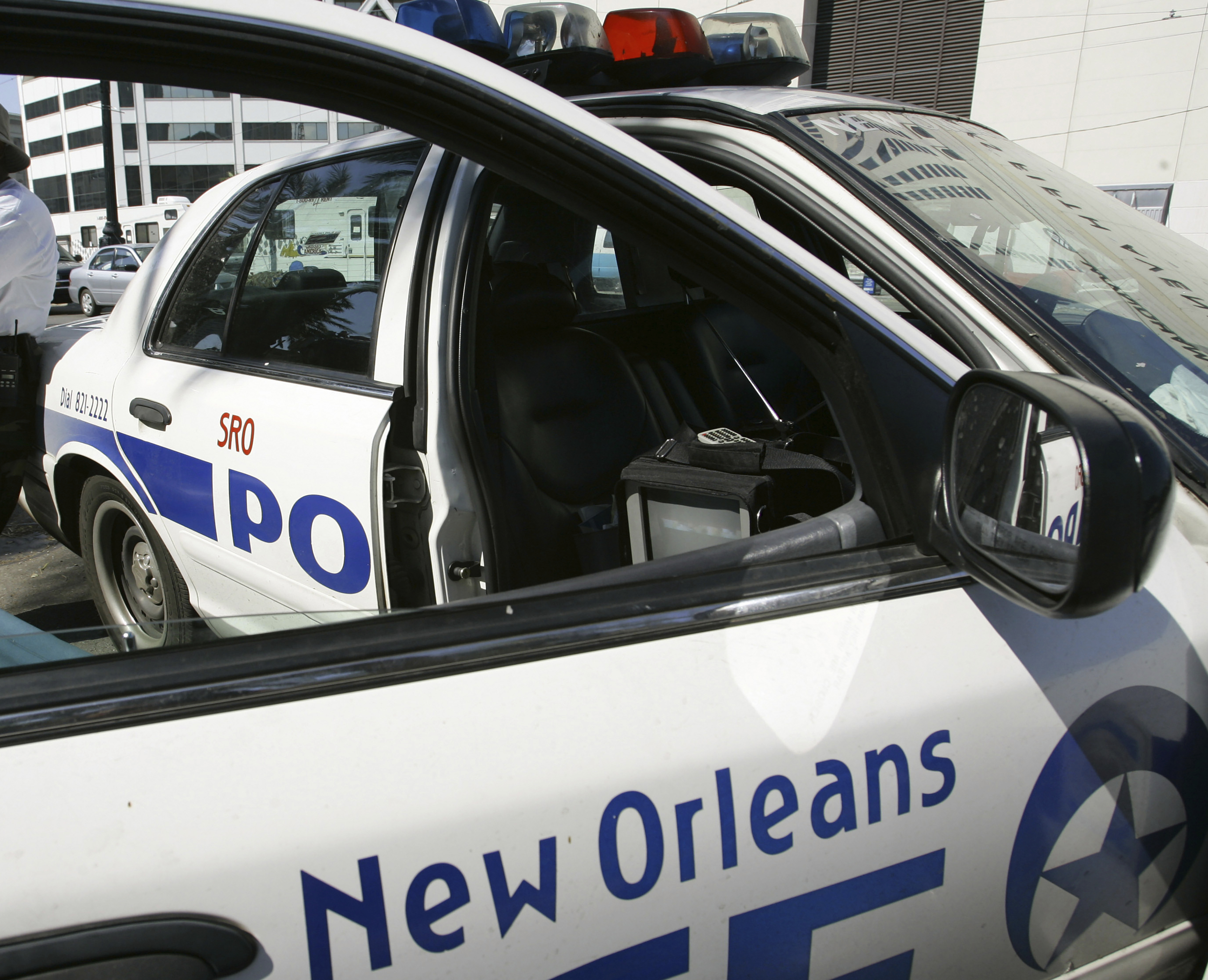 FILE - A New Orleans police officer leans against a patrol car, Sept. 11, 2005. (AP Photo/Anja Niedringhaus, file)