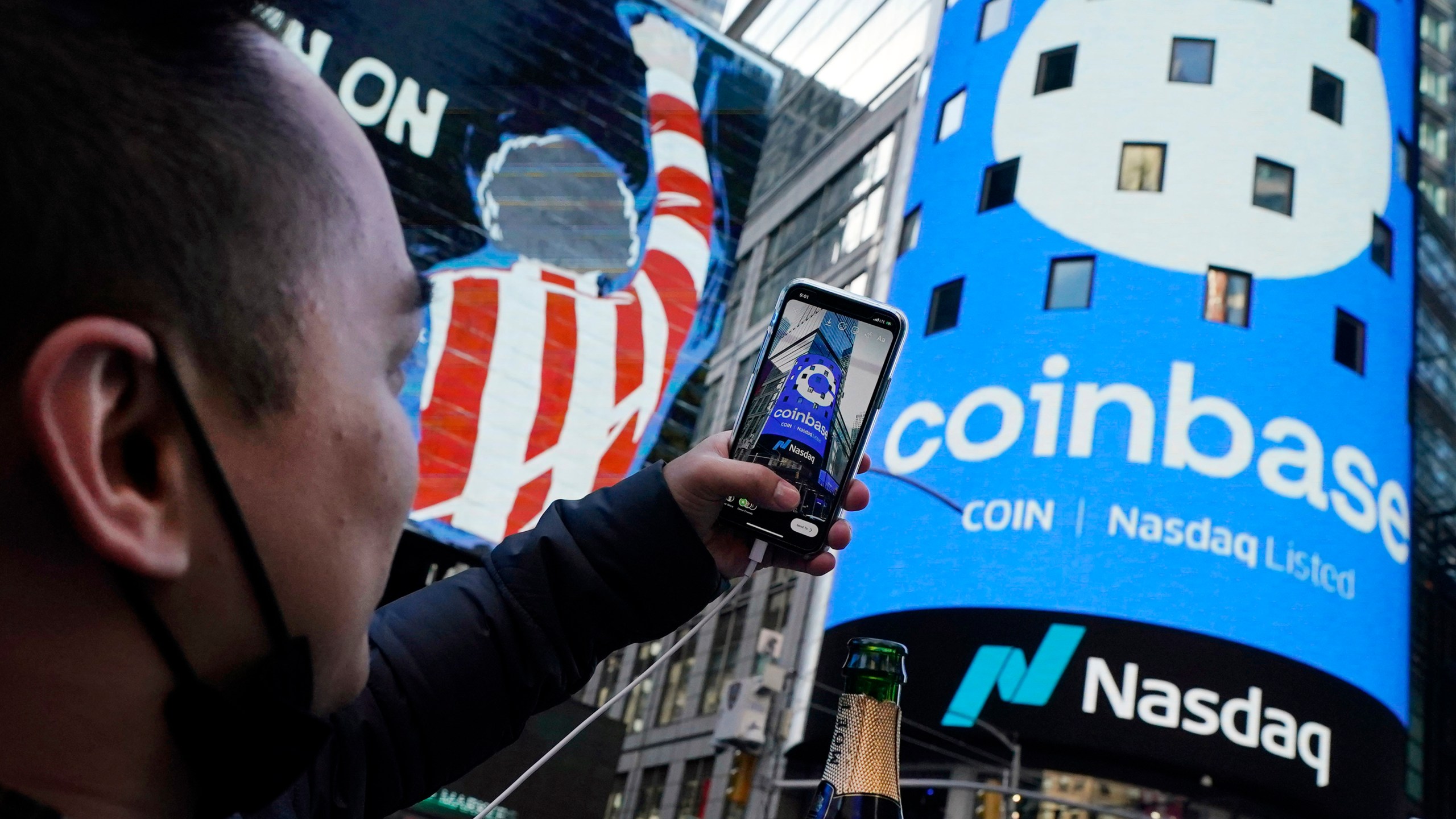 FILE - The Coinbase logo covers the Nasdaq MarketSite in New York's Times Square, April 14, 2021. (AP Photo/Richard Drew, File)