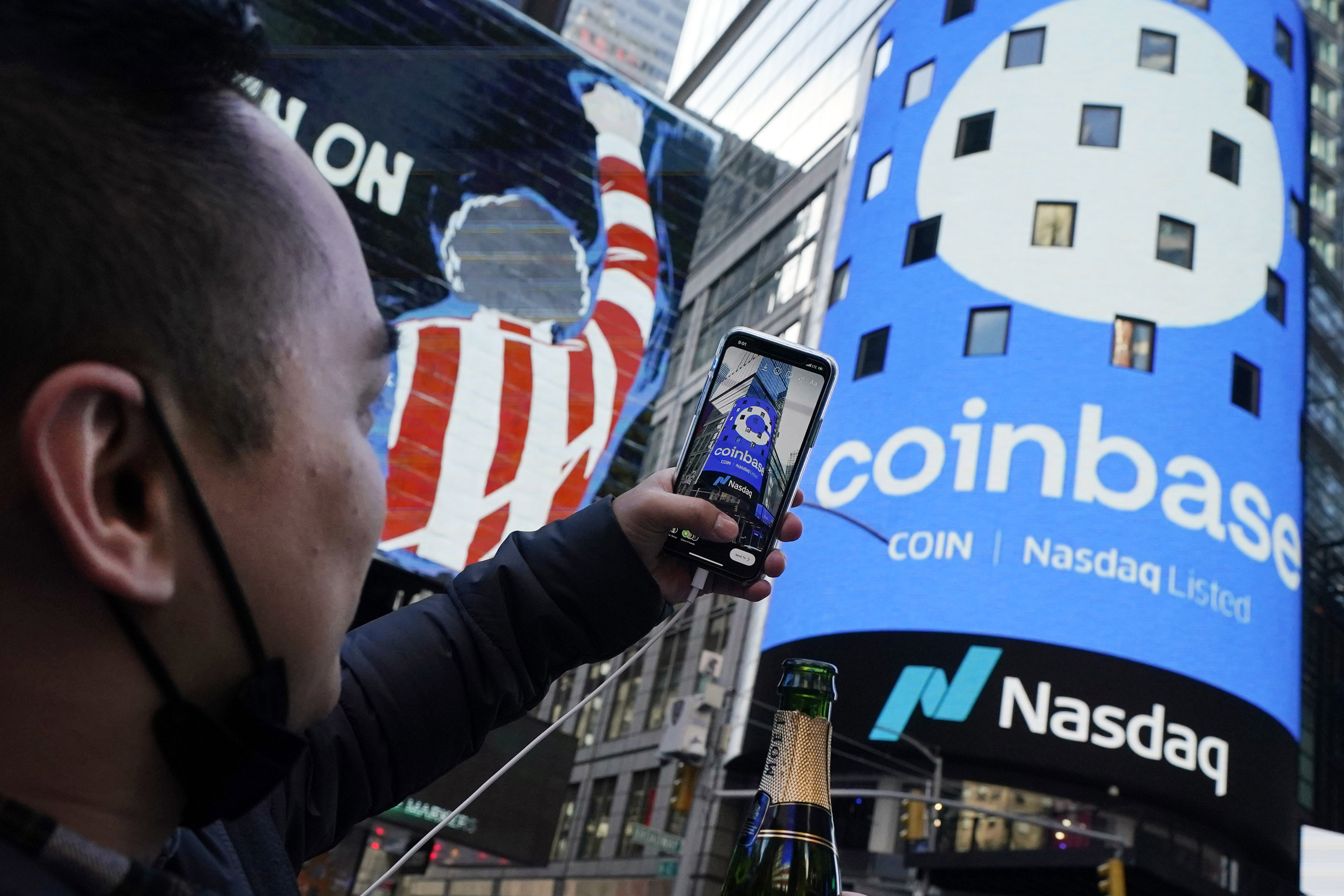 FILE - The Coinbase logo covers the Nasdaq MarketSite in New York's Times Square, April 14, 2021. (AP Photo/Richard Drew, File)