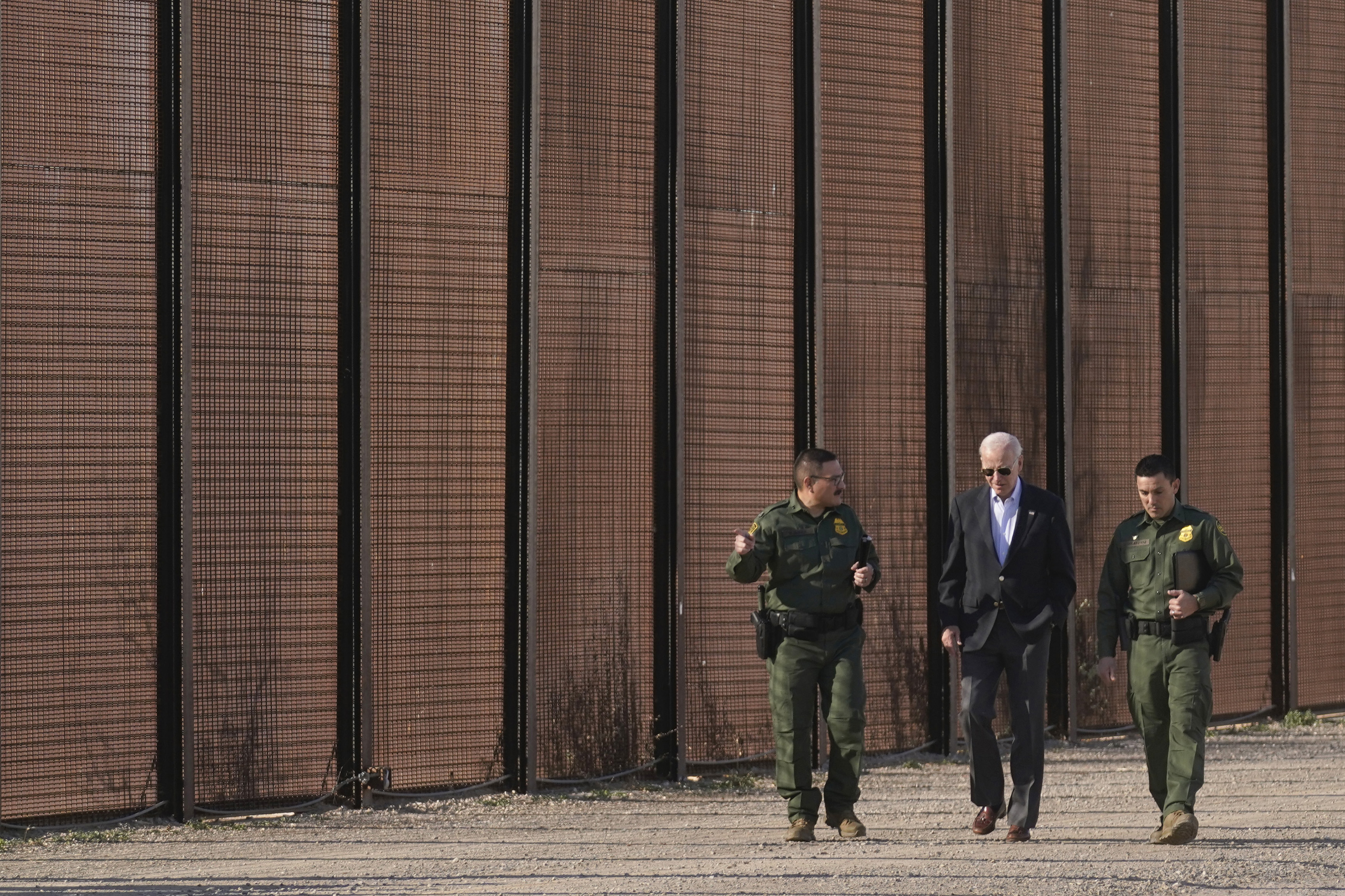 FILE - President Joe Biden walks with U.S. Border Patrol agents along a stretch of the U.S.-Mexico border in El Paso Texas, Jan. 8, 2023. (AP Photo/Andrew Harnik, File)