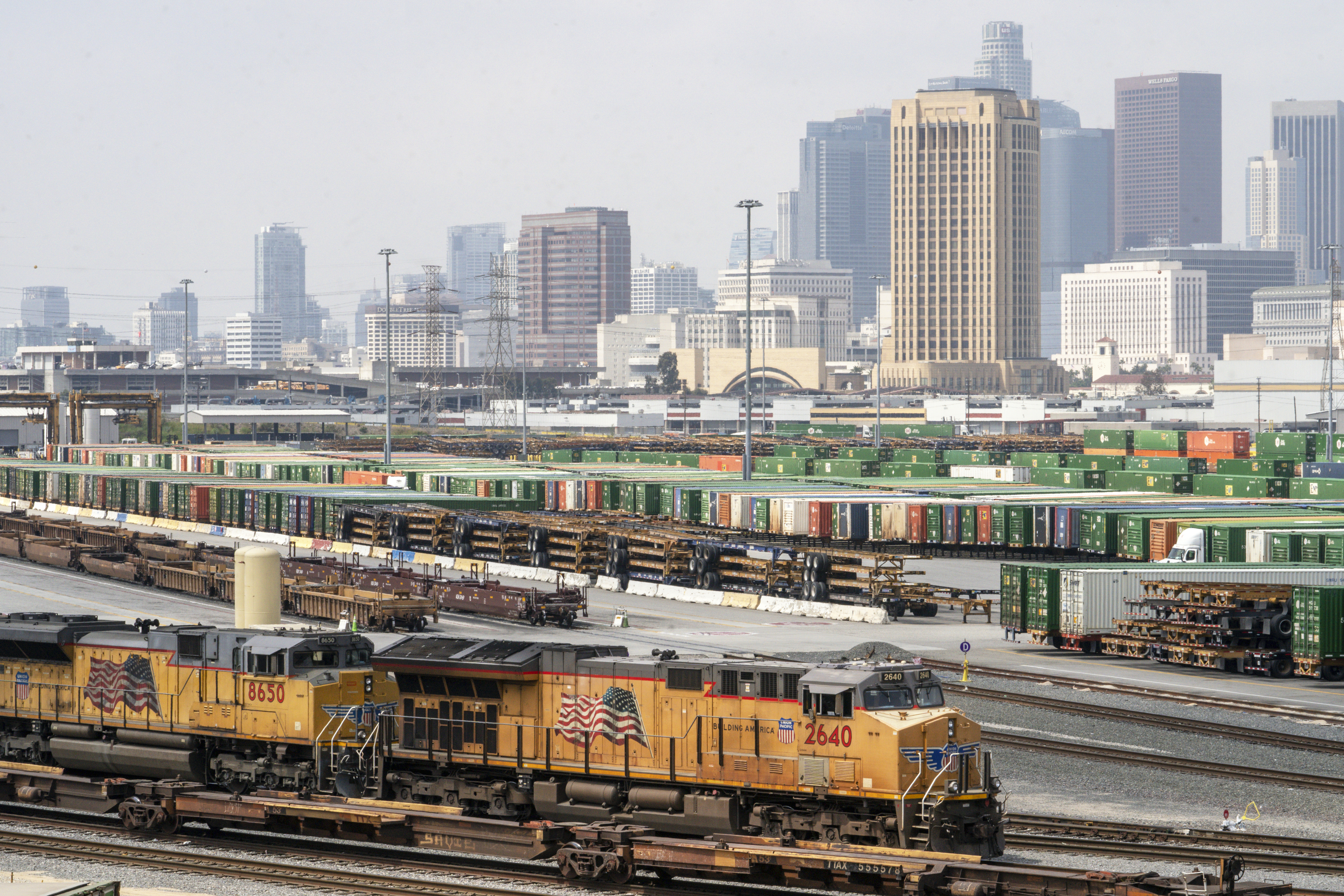 FILE - The Los Angeles skyline is seen above the Union Pacific LATC Intermodal Terminal on April 25, 2023, in Los Angeles. (AP Photo/Damian Dovarganes, File)