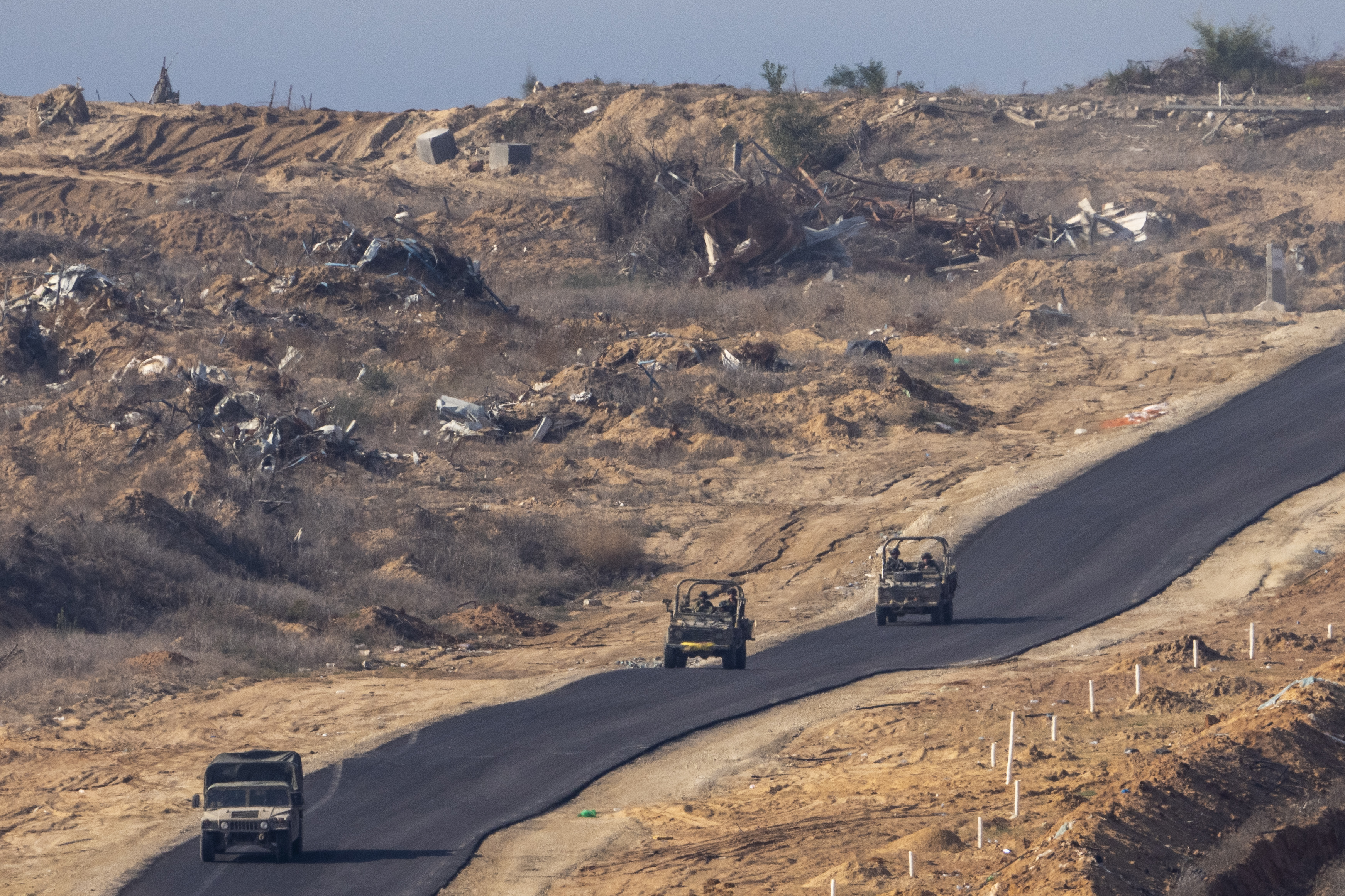 FILE - Israeli military vehicles move inside the Gaza Strip, as seen from southern Israel, on Jan. 7, 2025. (AP Photo/Ariel Schalit, File)