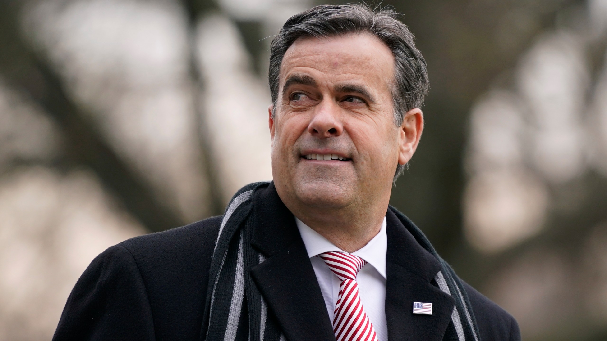 FILE - Director of National Intelligence John Ratcliffe waits to board Marine One with President Donald Trump on the South Lawn of the White House in Washington, Dec. 12, 2020. (AP Photo/Patrick Semansky, File)