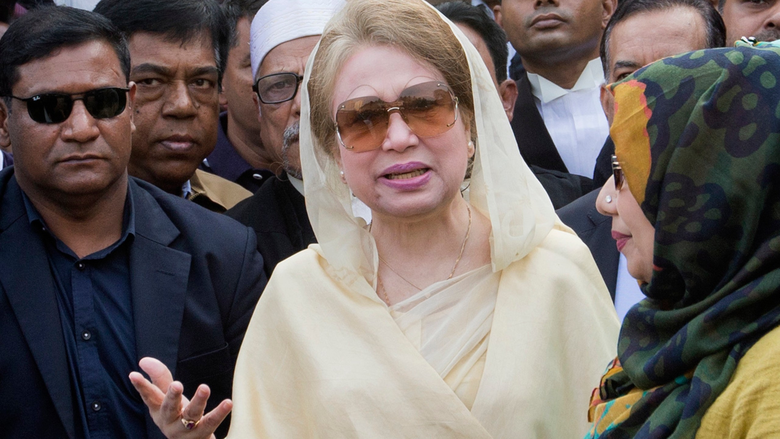 FILE- Bangladesh's former prime minister and Bangladesh Nationalist Party (BNP) chairperson Khaleda Zia, center, leaves after a court appearance in Dhaka, Bangladesh, Dec. 28, 2017. (AP Photo/A.M. Ahad, File)