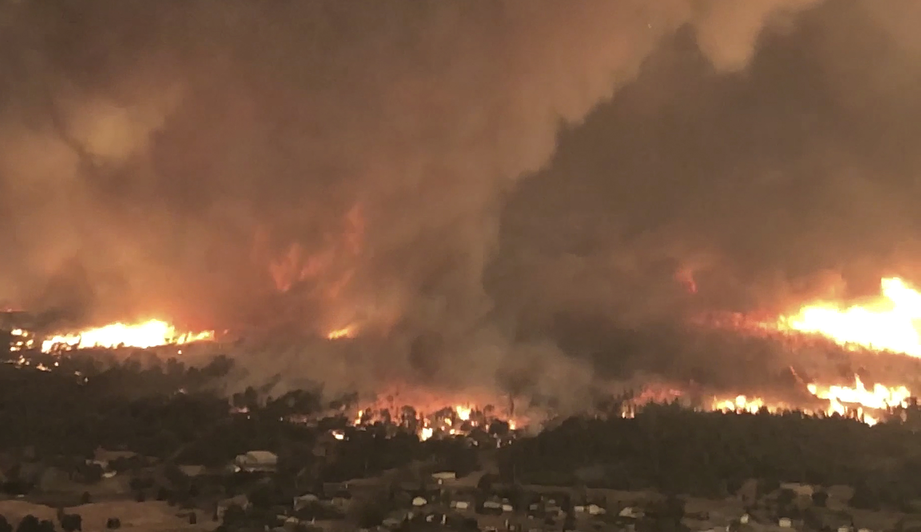 FILE - This image taken from video released by Cal Fire shows a fire tornado over Lake Keswick Estates, on July 26, 2018, near Redding, Calif. (Cal Fire via AP, File)