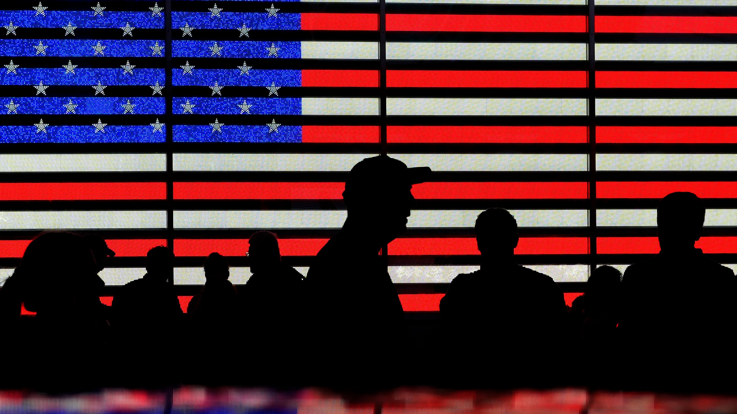 FILE - People stand in Times Square in New York, Aug. 9, 2024. (AP Photo/Pamela Smith, File)