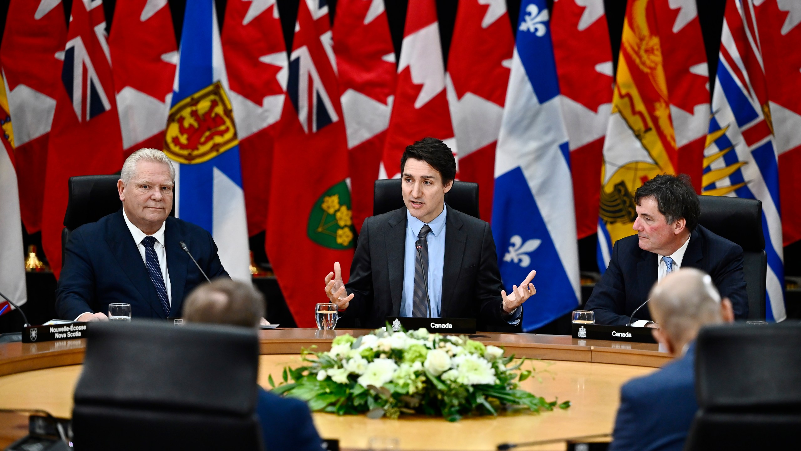 Canada Prime Minister Justin Trudeau makes his opening remarks as Ontario Premier Doug Ford, left, and Minister of Finance, Public Safety and Intergovernmental Affairs Dominic LeBlanc, right, look on at a first ministers meeting in Ottawa on Wednesday, Jan. 15, 2025. (Justin Tang/The Canadian Press via AP)