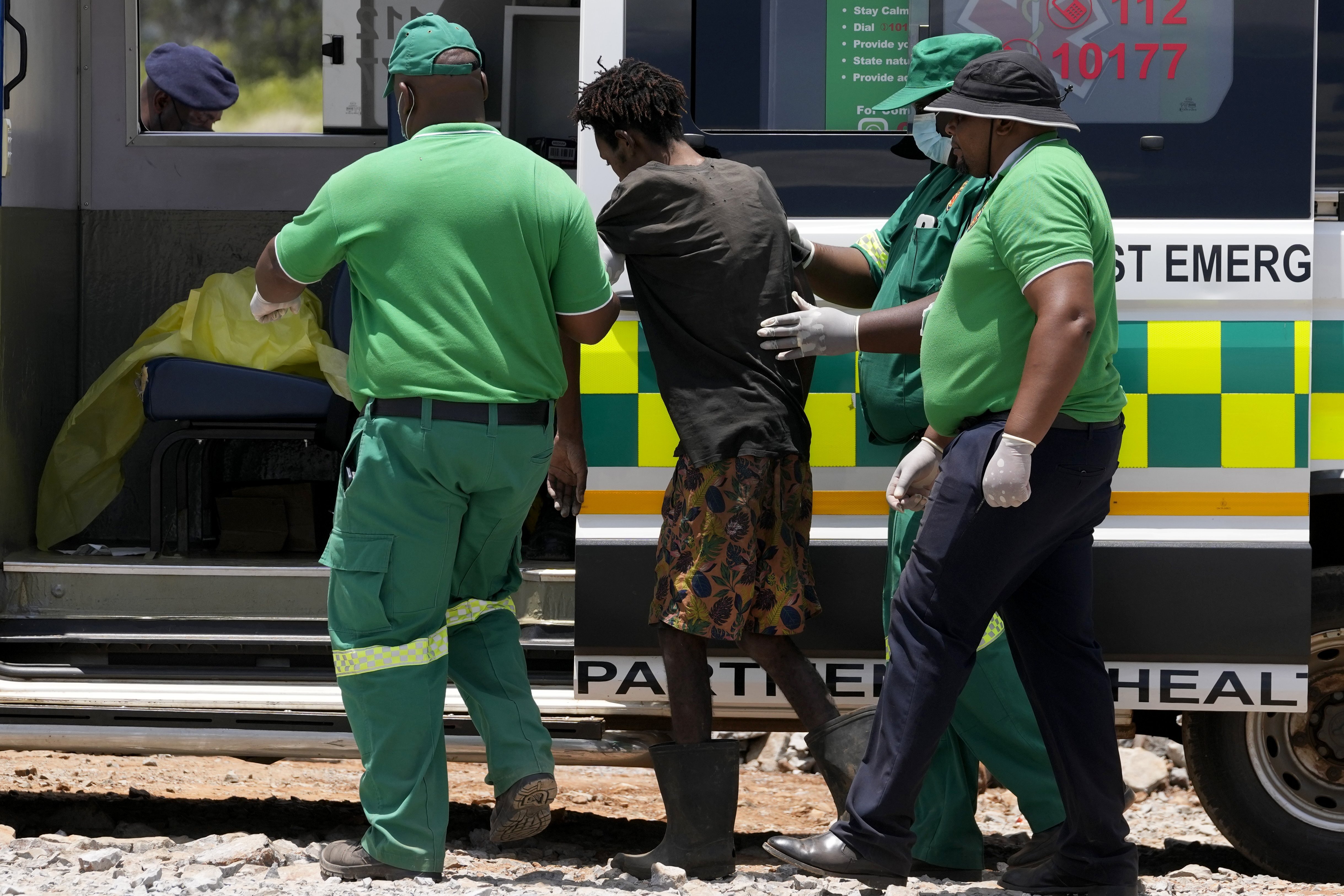 Rescuer workers assist an illegal miner who has been trapped deep in an abandoned gold mine for months, in Stilfontein, South Africa, Tuesday, Jan. 14, 2025. (AP Photo/Themba Hadebe)