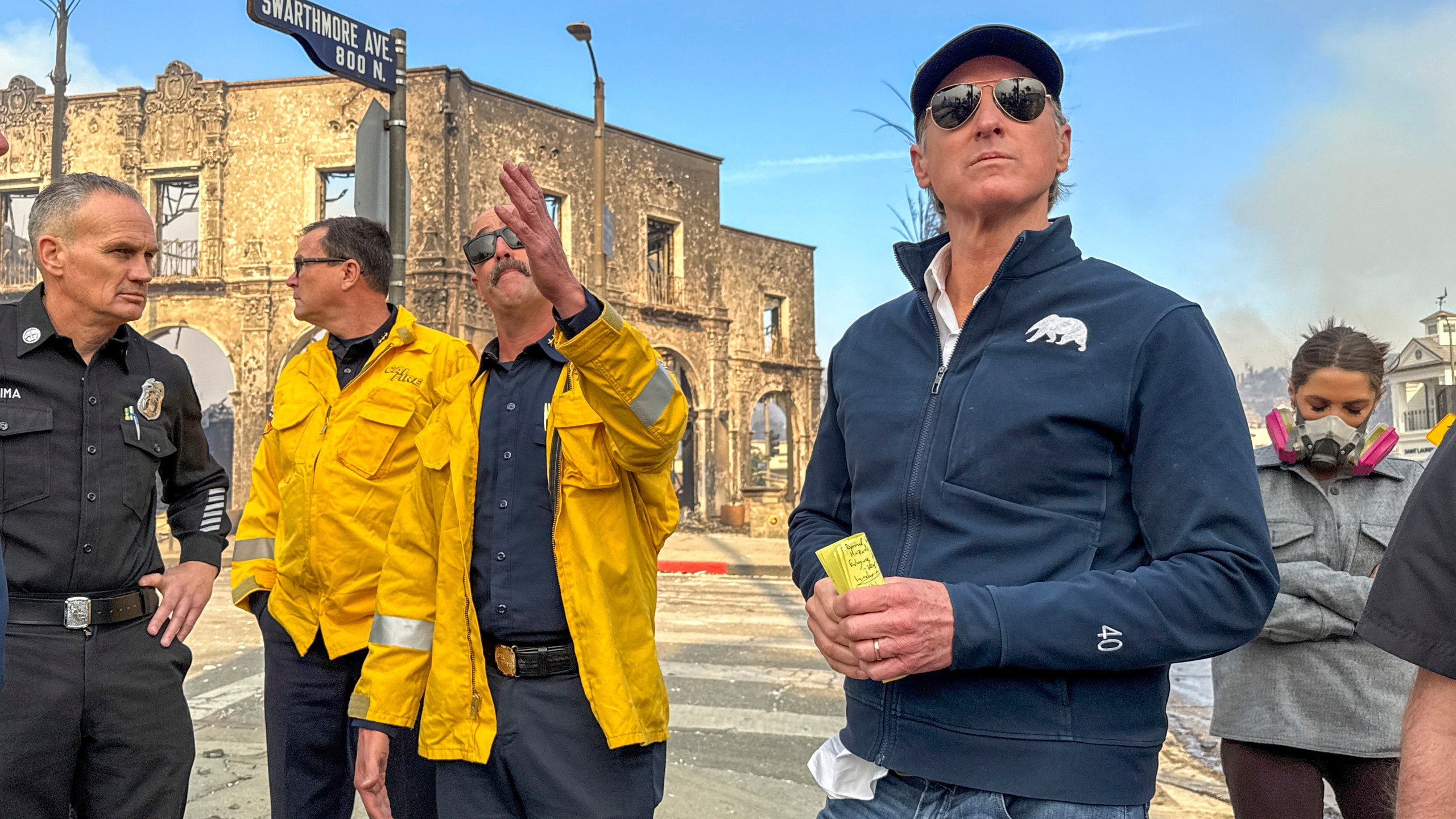 California Governor Gavin Newsom, right, surveys damage in Pacific Palisades with CalFire's Nick Schuler during the Palisades Fire on Wednesday, Jan. 8, 2025, in Pacific Palisades, Calif. (Jeff Gritchen/The Orange County Register via AP)