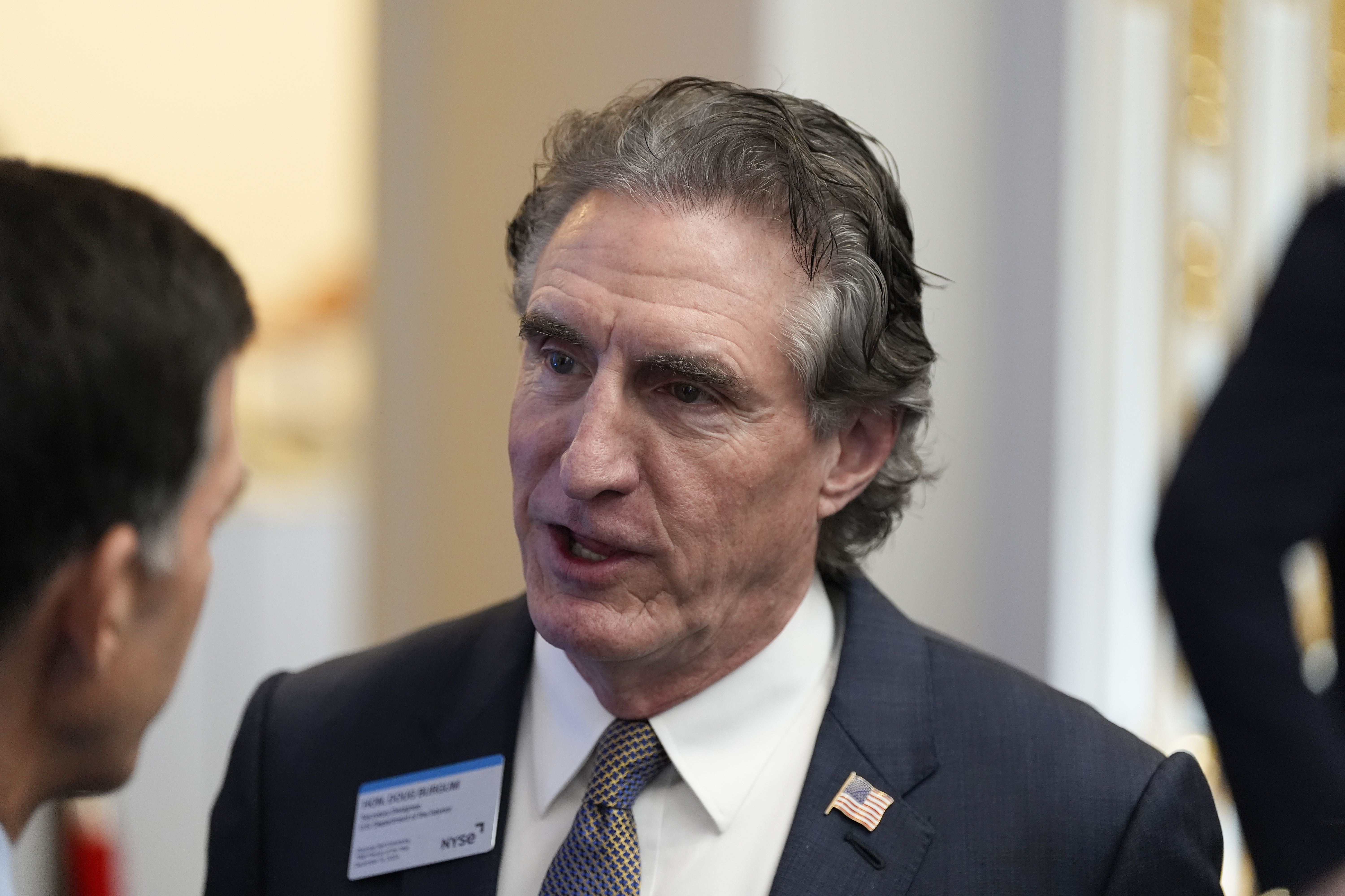 FILE - Gov. Doug Burgum, R-N.D., chats at the New York Stock Exchange before President-elect Donald Trump arrives to ring the opening bell, Dec. 12, 2024, in New York. (AP Photo/Alex Brandon, File)