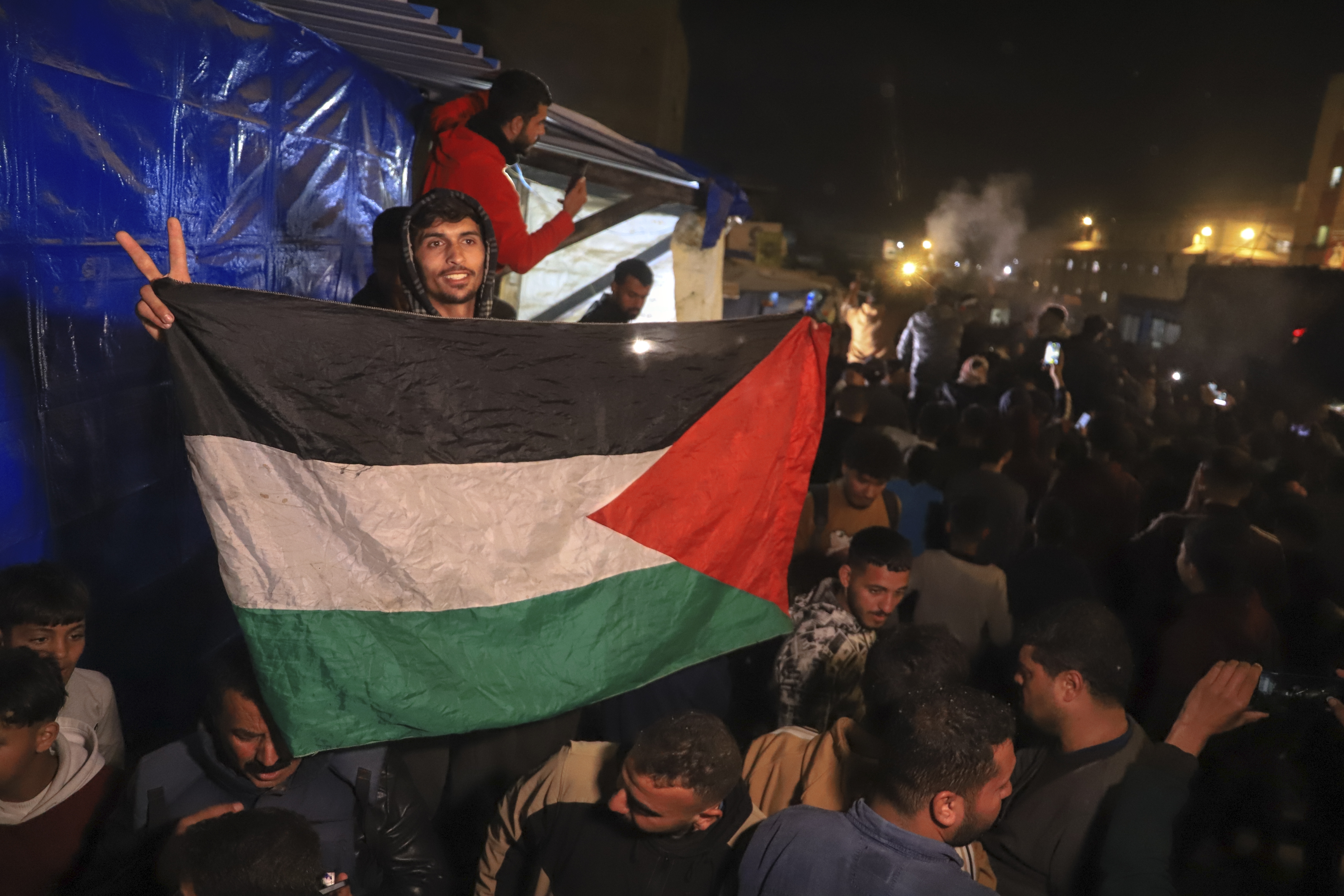 Palestinians celebrate the imminent announcement of a ceasefire deal between Hamas and Israel in Khan Younis, central Gaza Strip, Wednesday, Jan. 15, 2025.(AP Photo/(AP Photo/Mariam Dagga)