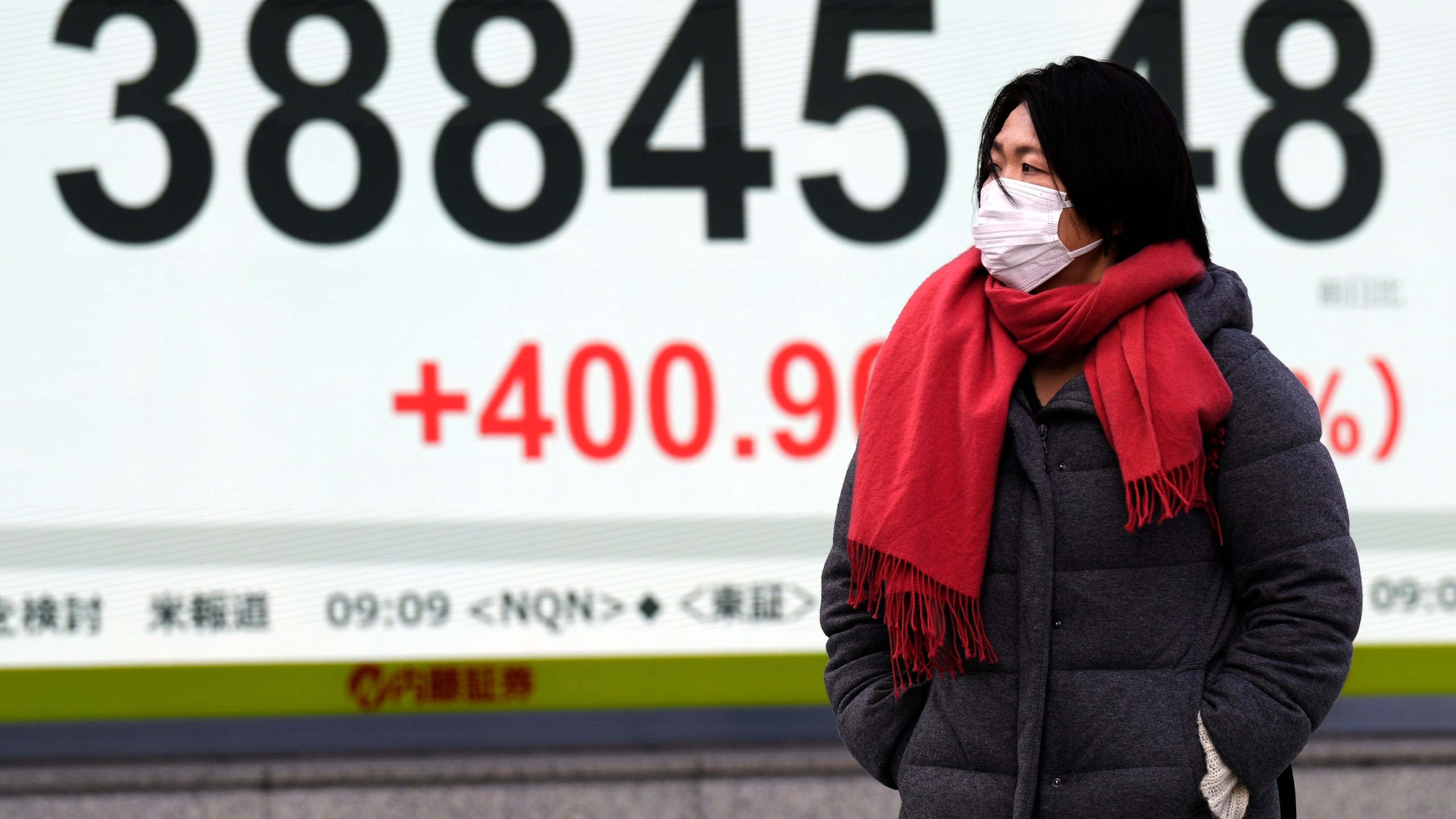 A person walks in front of an electronic stock board showing Japan's Nikkei index at a securities firm Thursday, Jan. 16, 2025, in Tokyo. (AP Photo/Eugene Hoshiko)